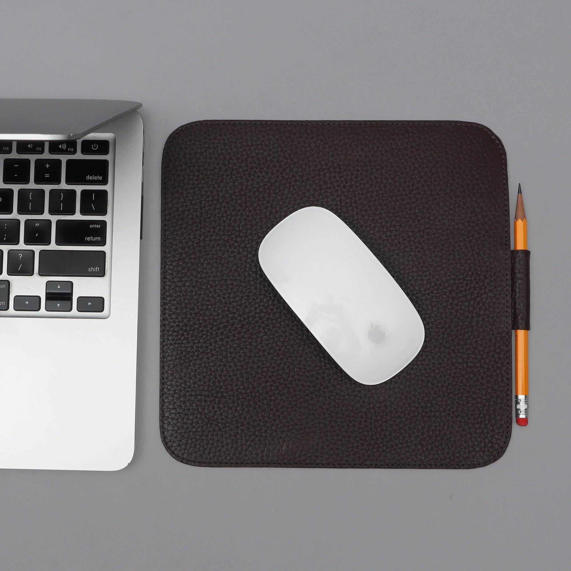 A square mouse pad made of premium full grain leather, featuring a smooth surface and space for a pen or Apple Pencil, showcasing its elegant design.