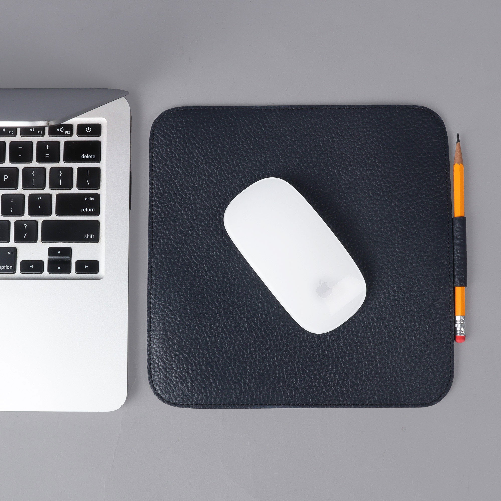 A premium square mouse pad made from full grain leather, featuring a smooth surface and burnished edges, perfect for enhancing workspace aesthetics.