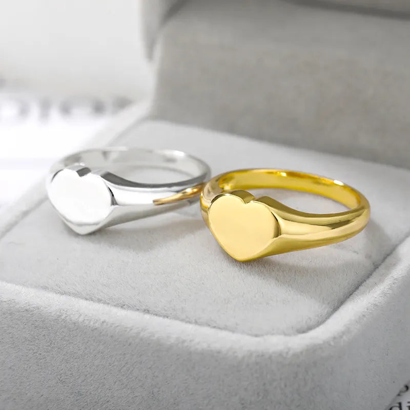 A stylish stainless steel heart ring designed for women, showcasing a trendy heart shape perfect for weddings and special occasions.