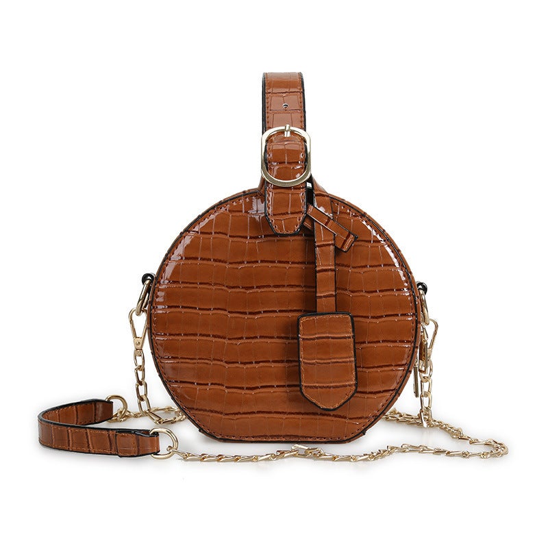 A stylish one-shoulder small round messenger bag with a crocodile pattern, made of durable PU fabric, perfect for street fashion.