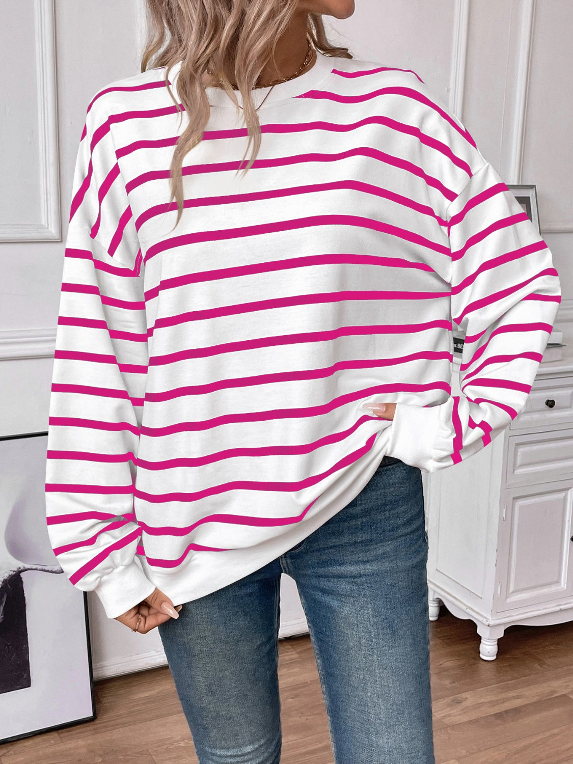 Striped round neck long sleeve sweatshirt in a stylish design, showcasing its comfortable fit and fabric texture.