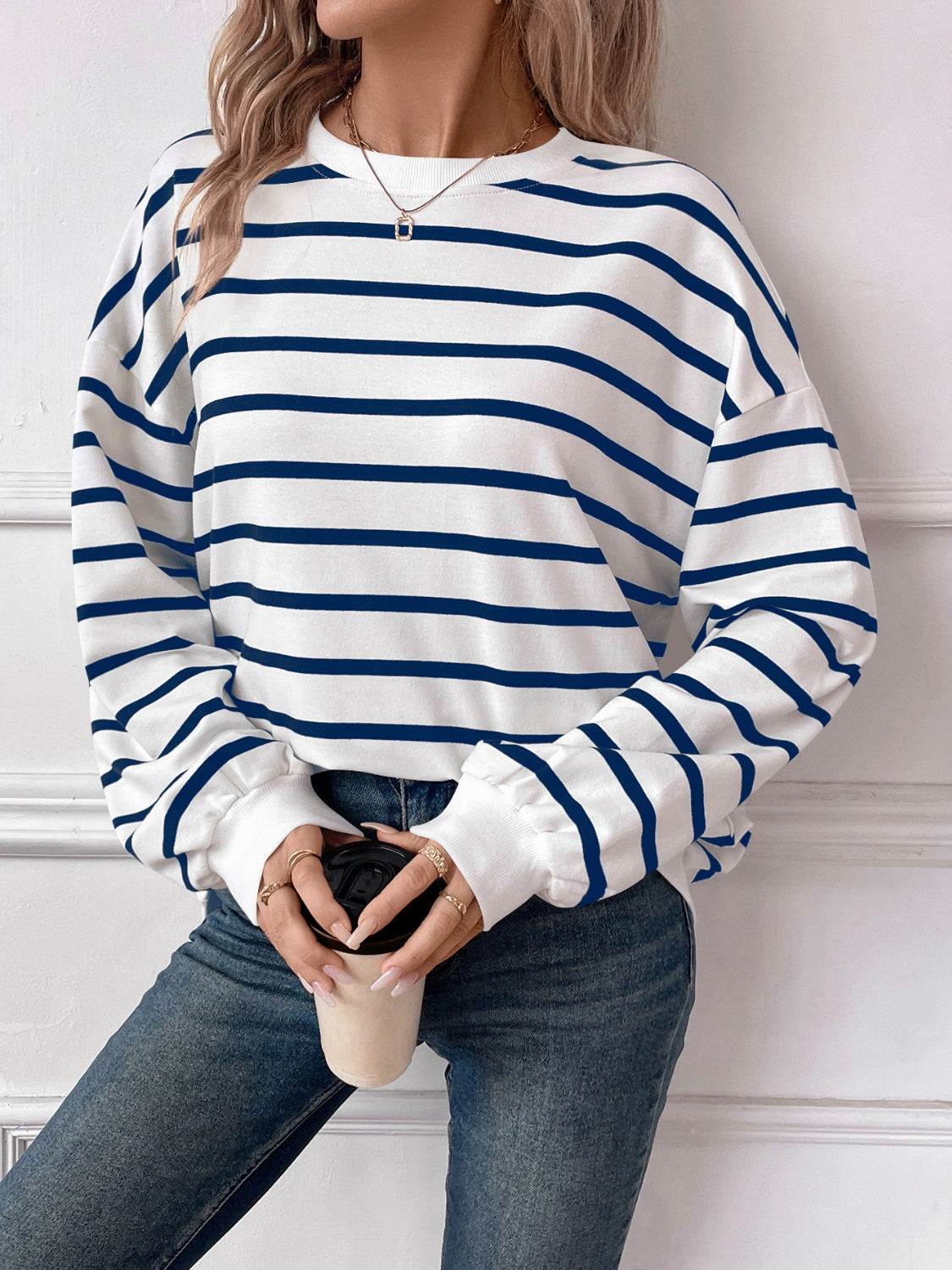 Striped round neck long sleeve sweatshirt in a stylish design, showcasing its comfortable fit and fabric texture.