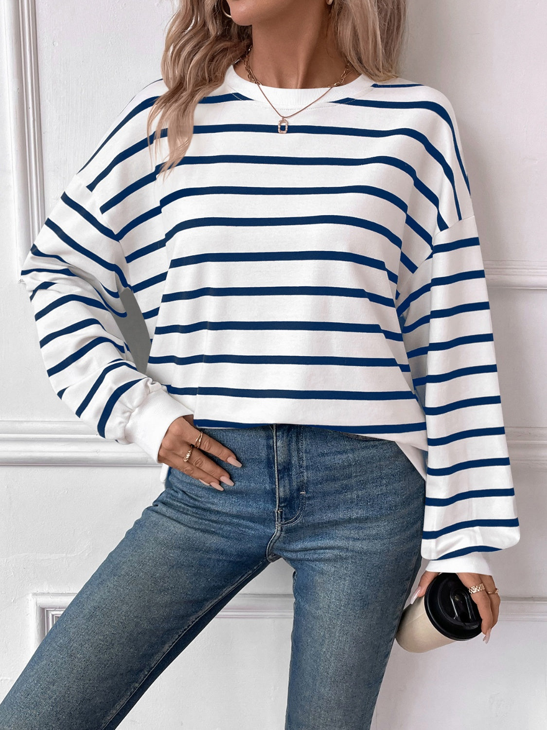 Striped round neck long sleeve sweatshirt in a stylish design, showcasing its comfortable fit and fabric texture.