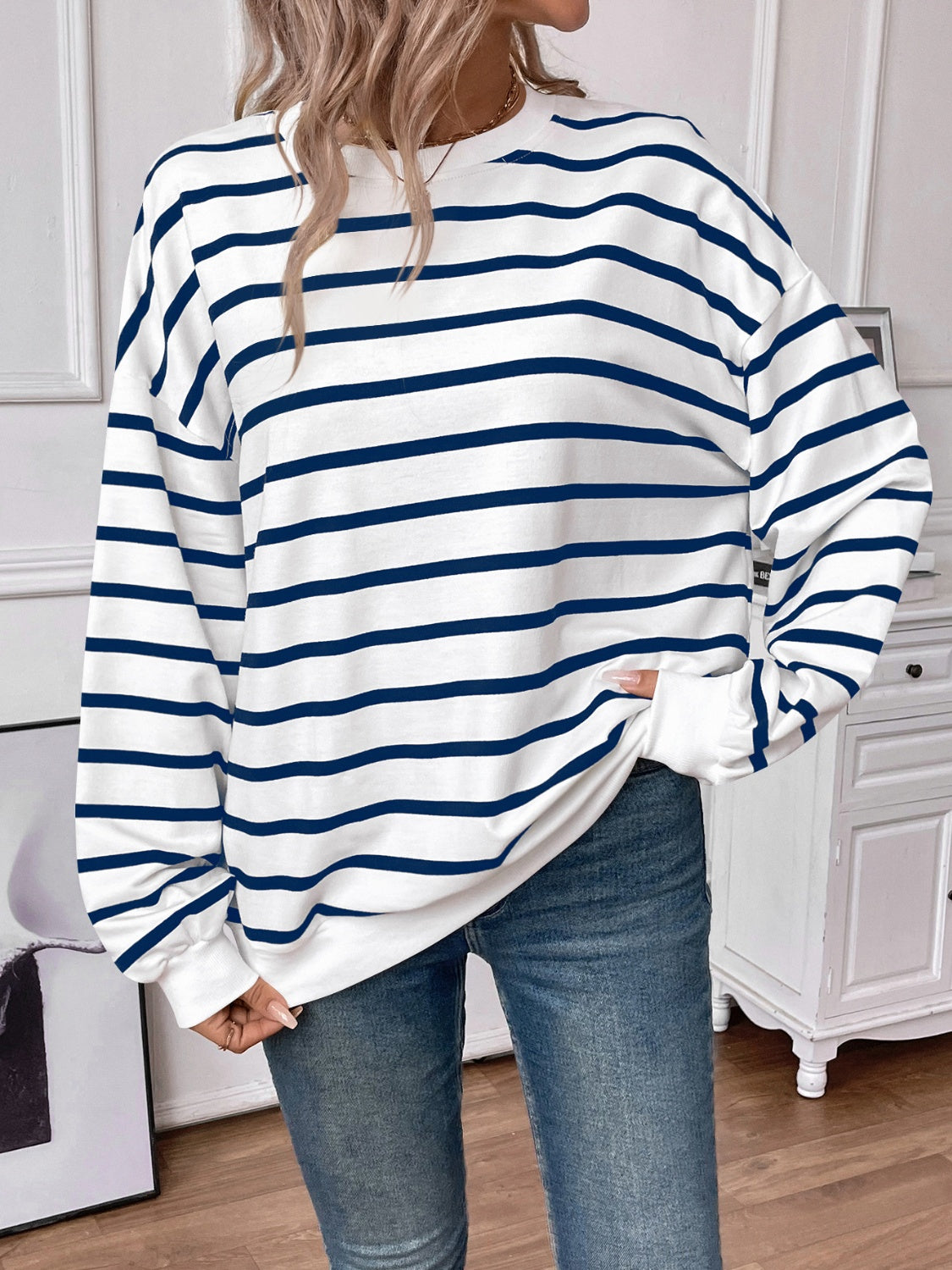 Striped round neck long sleeve sweatshirt in a stylish design, showcasing its comfortable fit and fabric texture.