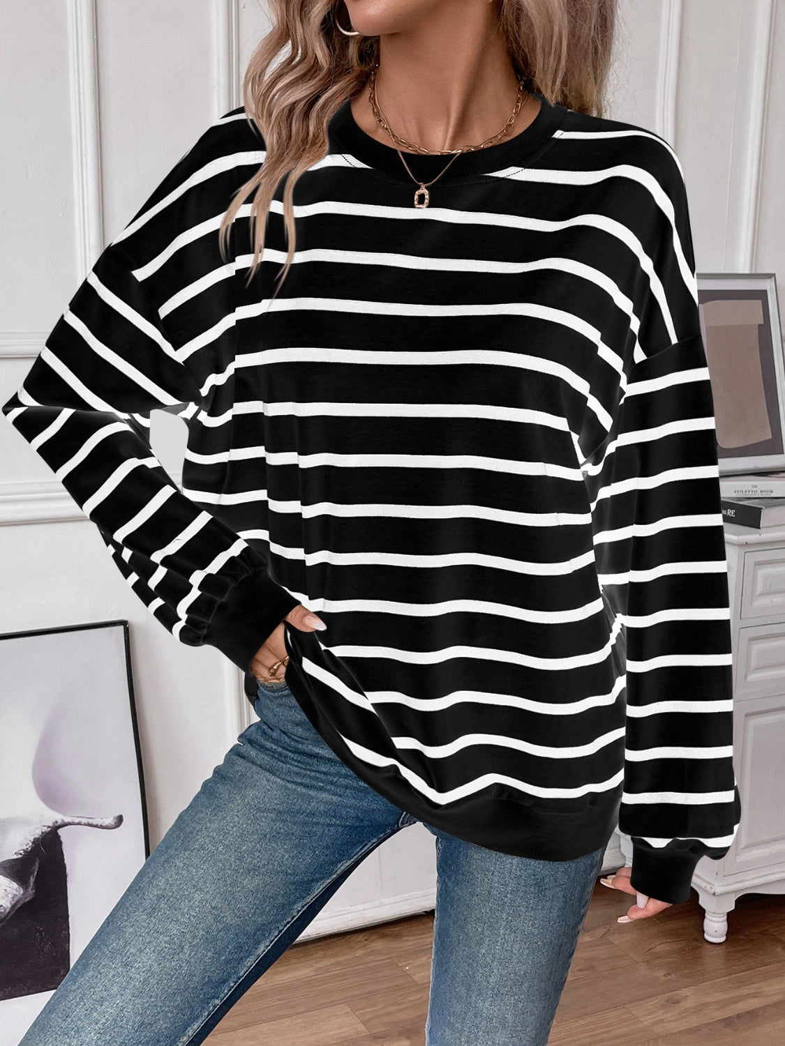 Striped round neck long sleeve sweatshirt in a stylish design, showcasing its comfortable fit and fabric texture.