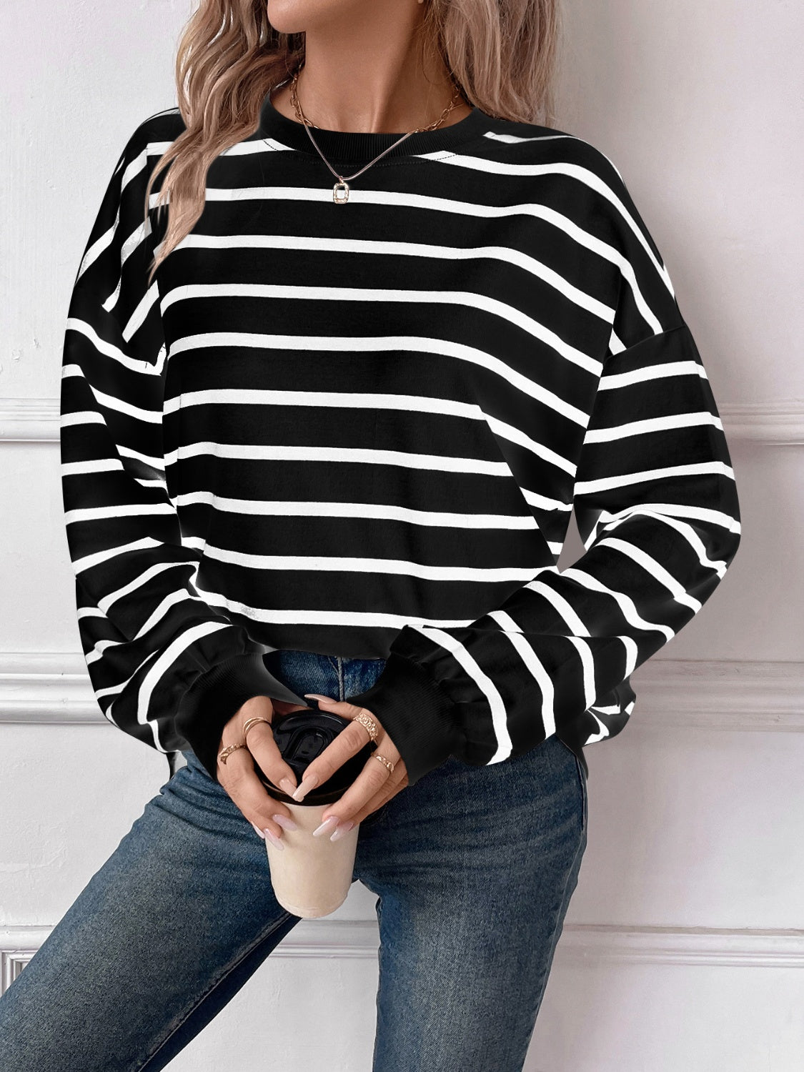 Striped round neck long sleeve sweatshirt in a stylish design, showcasing its comfortable fit and fabric texture.