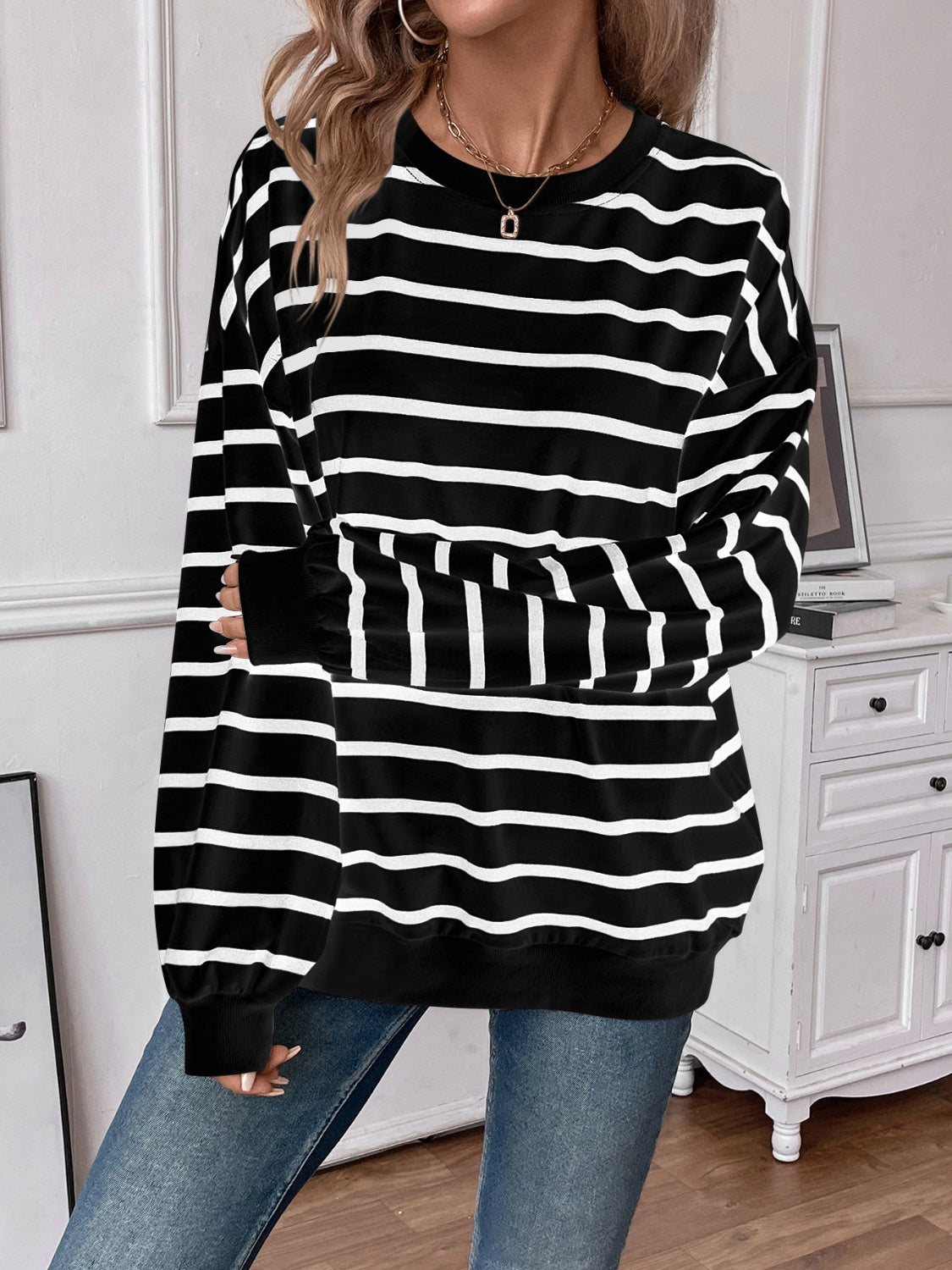 Striped round neck long sleeve sweatshirt in a stylish design, showcasing its comfortable fit and fabric texture.