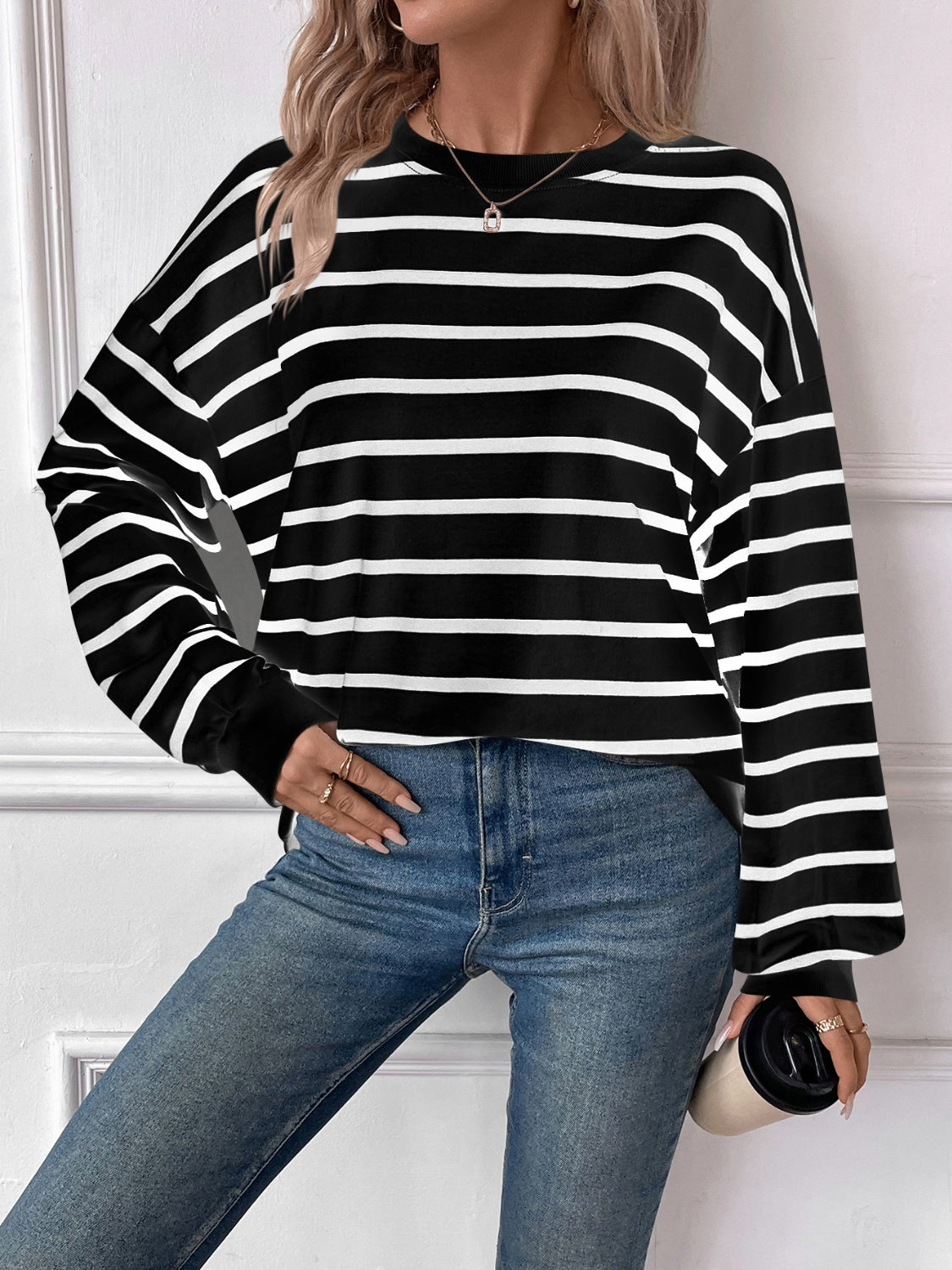 Striped round neck long sleeve sweatshirt in a stylish design, showcasing its comfortable fit and fabric texture.