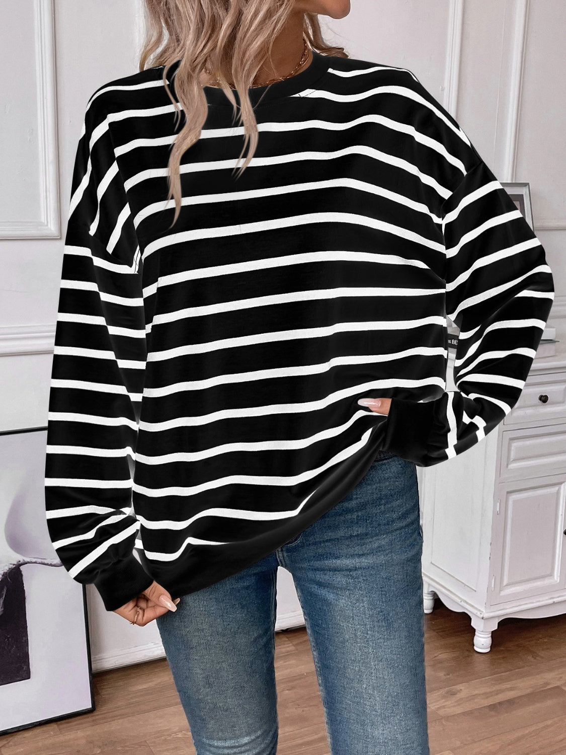 Striped round neck long sleeve sweatshirt in a stylish design, showcasing its comfortable fit and fabric texture.