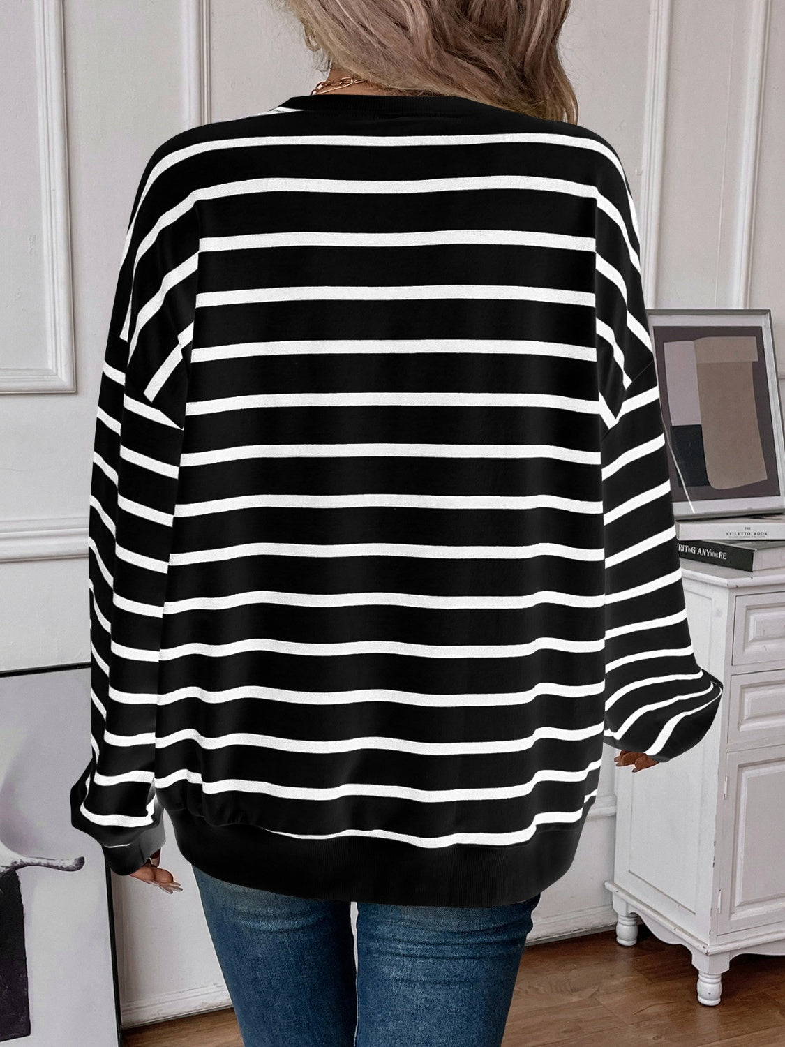 Striped round neck long sleeve sweatshirt in a stylish design, showcasing its comfortable fit and fabric texture.