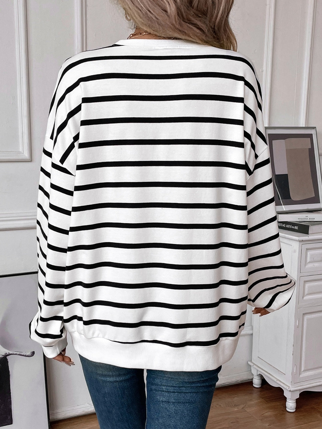 Striped round neck long sleeve sweatshirt in a stylish design, showcasing its comfortable fit and fabric texture.