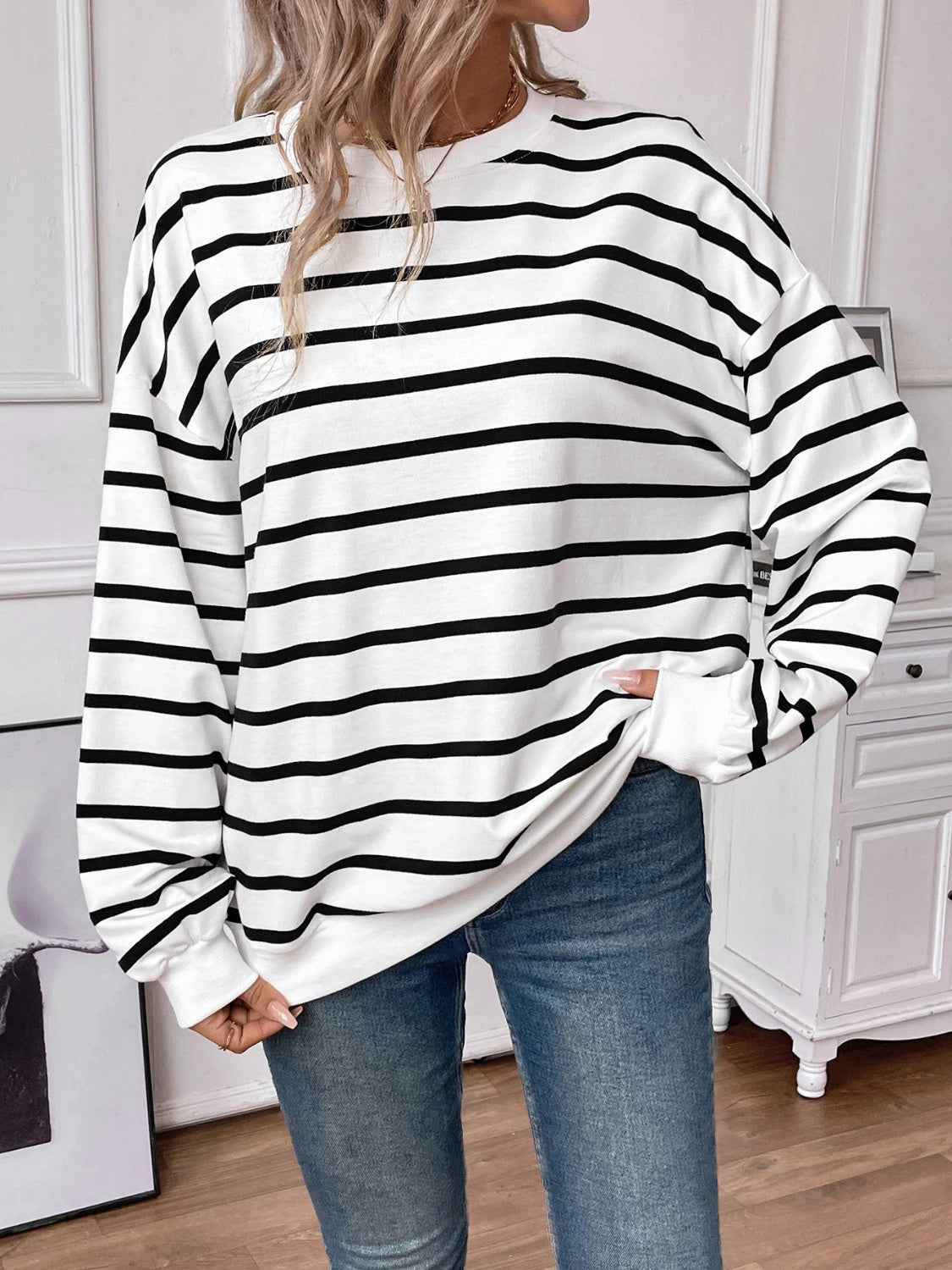 Striped round neck long sleeve sweatshirt in a stylish design, showcasing its comfortable fit and fabric texture.