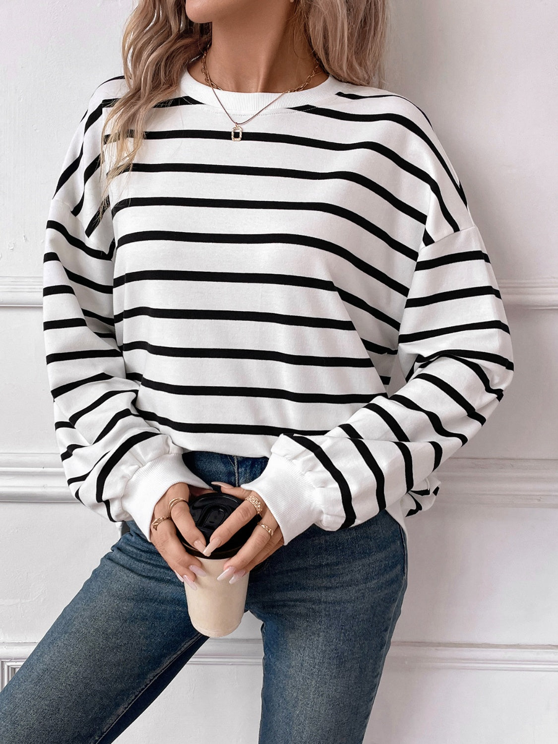 Striped round neck long sleeve sweatshirt in a stylish design, showcasing its comfortable fit and fabric texture.