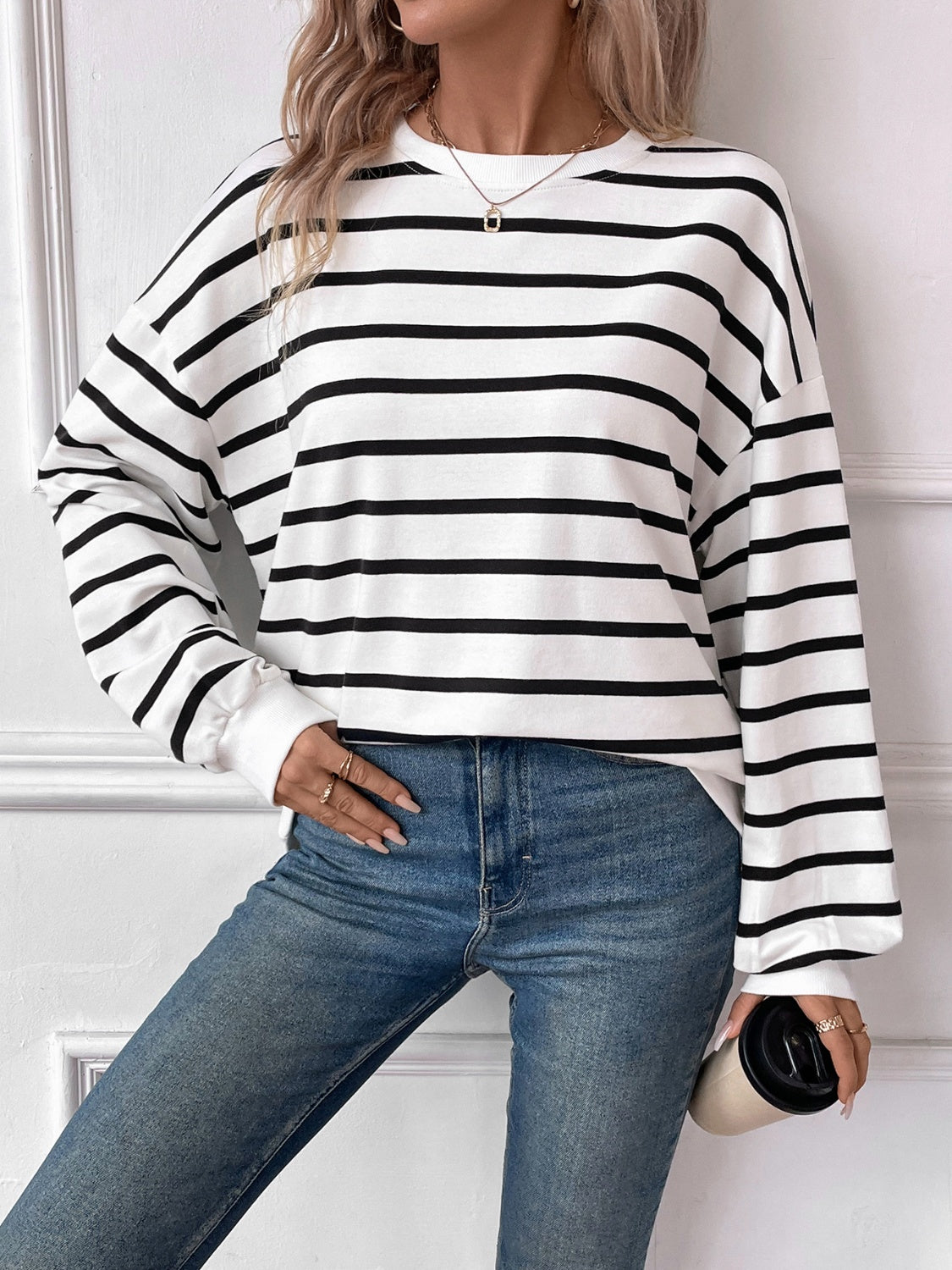 Striped round neck long sleeve sweatshirt in a stylish design, showcasing its comfortable fit and fabric texture.