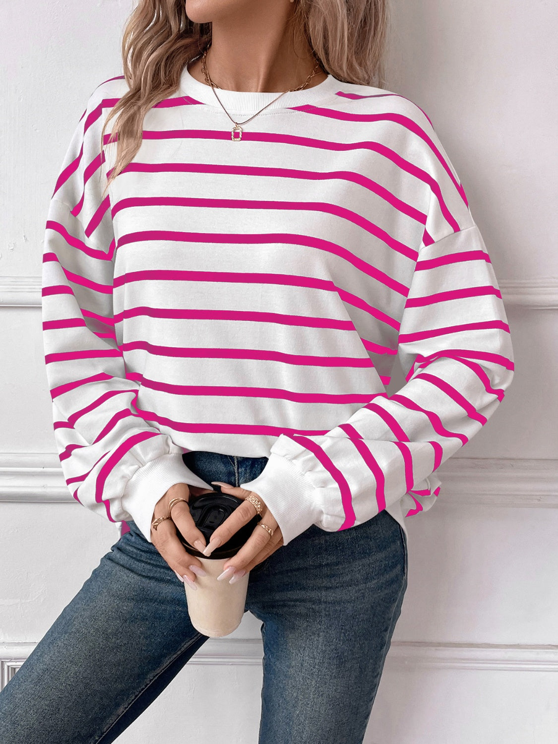 Striped round neck long sleeve sweatshirt in a stylish design, showcasing its comfortable fit and fabric texture.