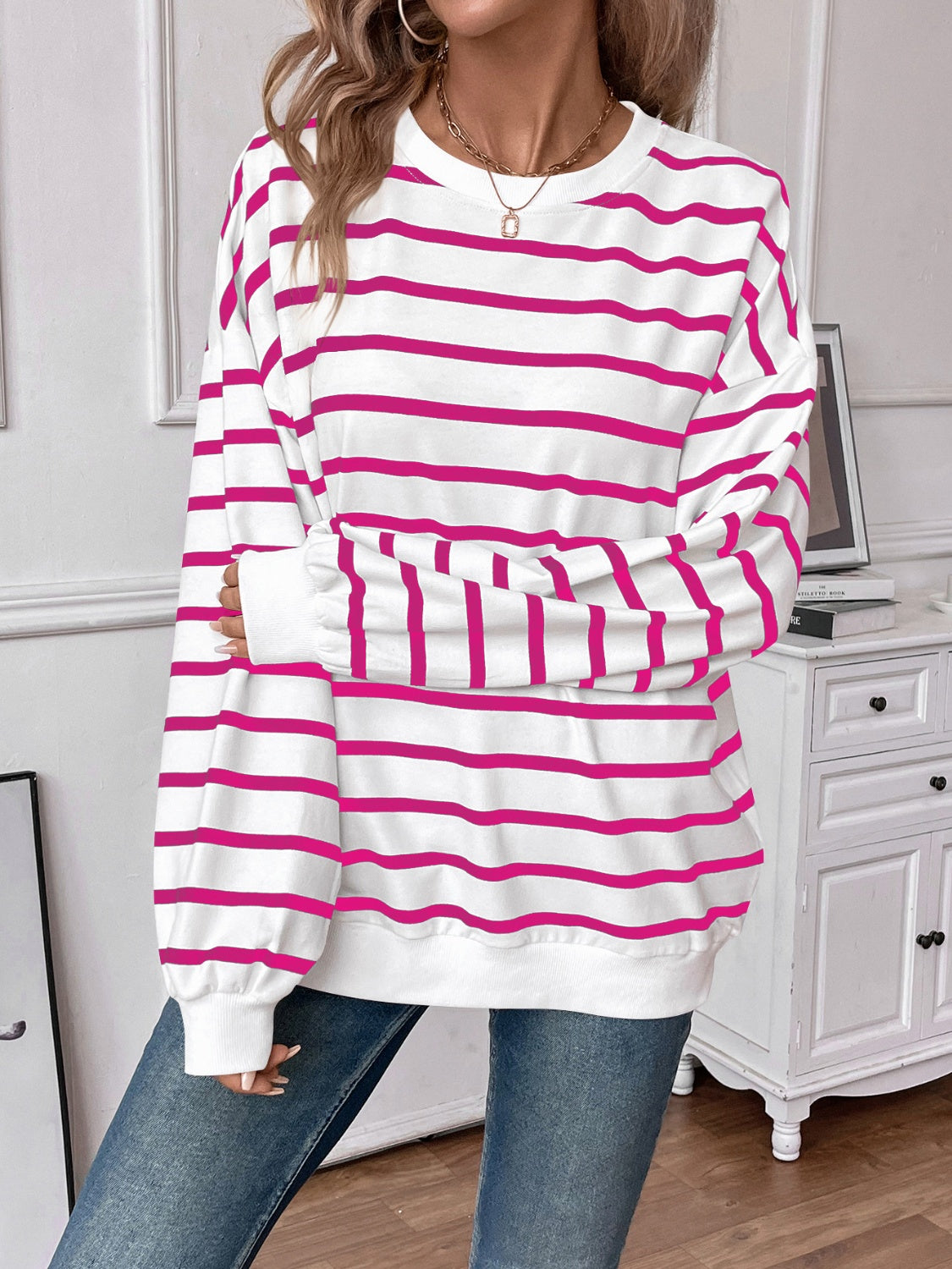 Striped round neck long sleeve sweatshirt in a stylish design, showcasing its comfortable fit and fabric texture.