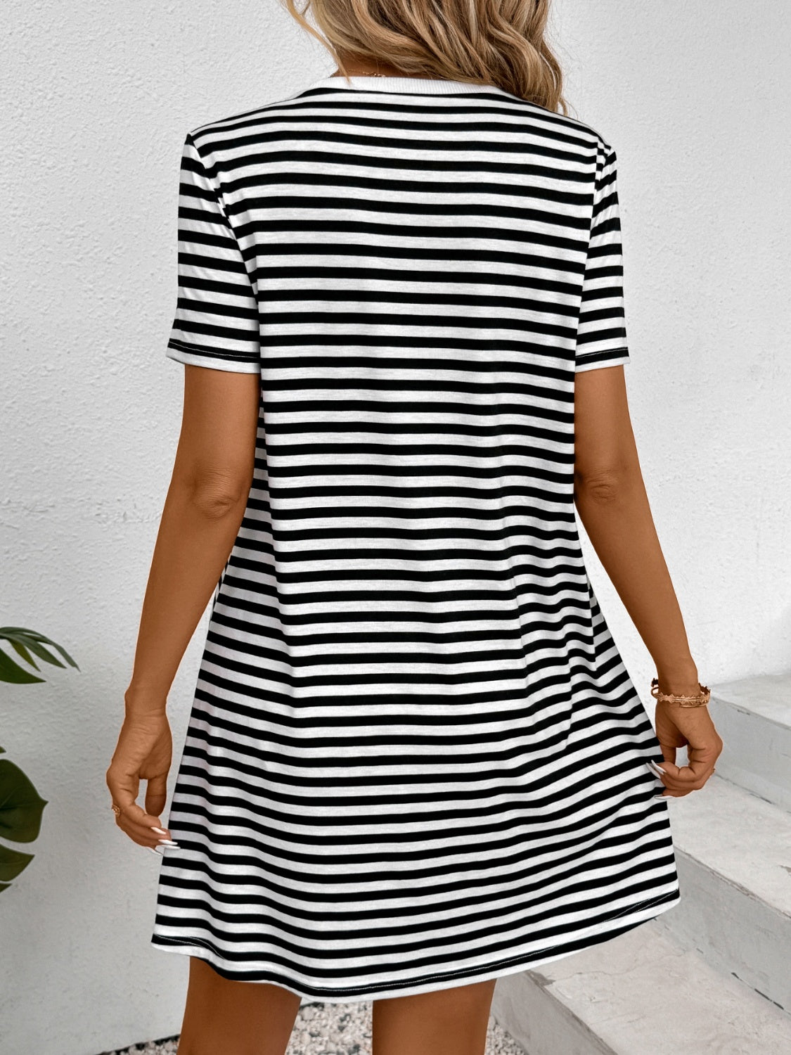 A stylish striped round neck short sleeve dress displayed on a mannequin, showcasing its comfortable fit and modern design.