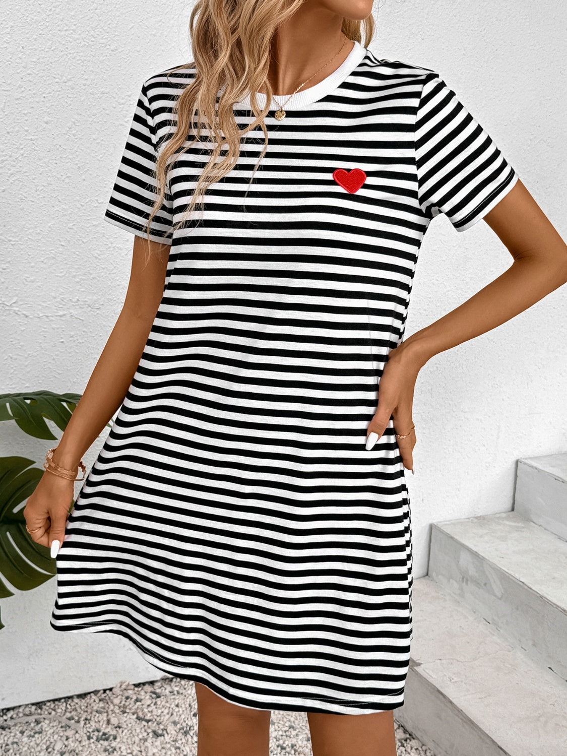 A stylish striped round neck short sleeve dress displayed on a mannequin, showcasing its comfortable fit and modern design.