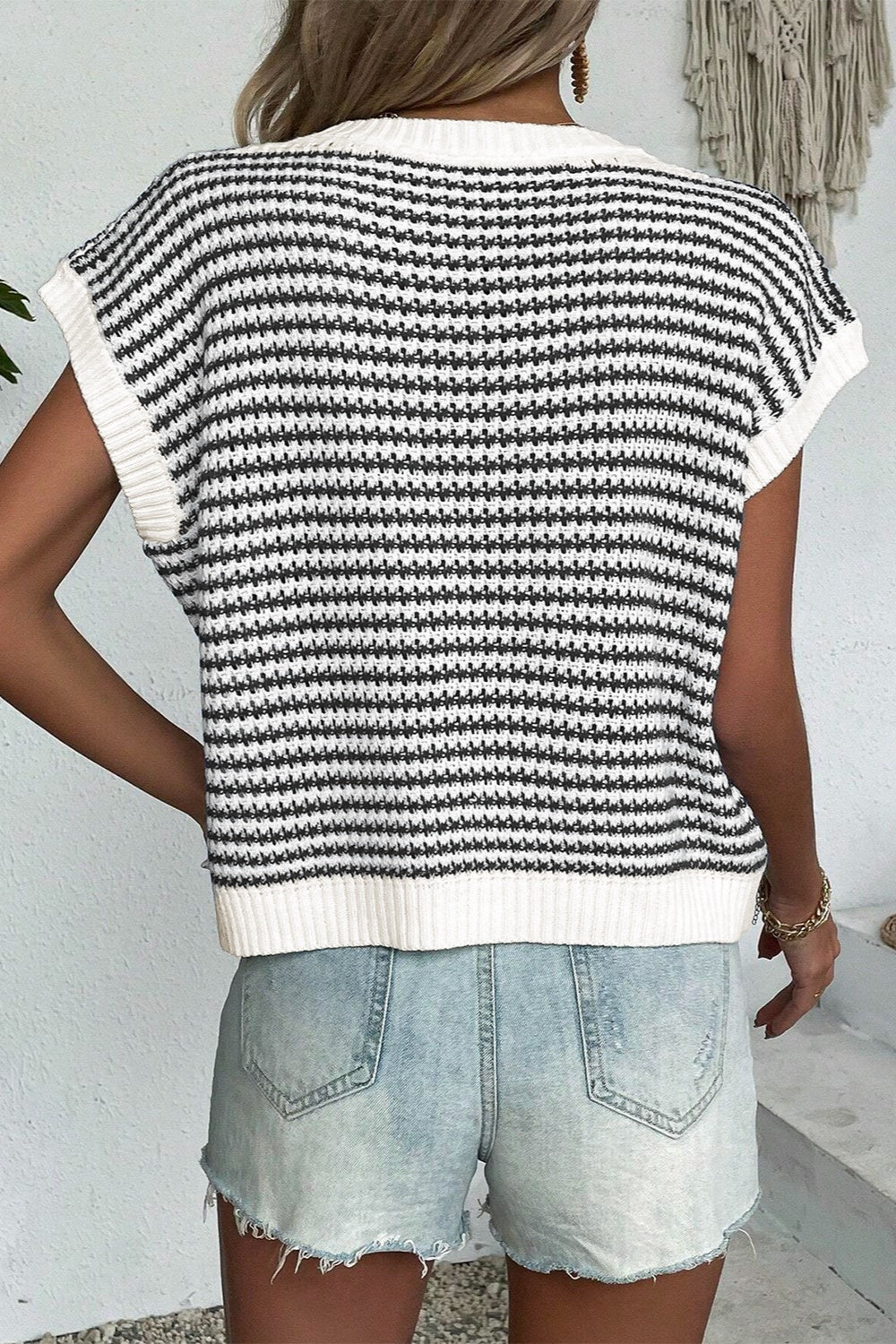 A stylish striped round neck sweater vest in a cozy acrylic-cotton blend, perfect for layering or casual wear.