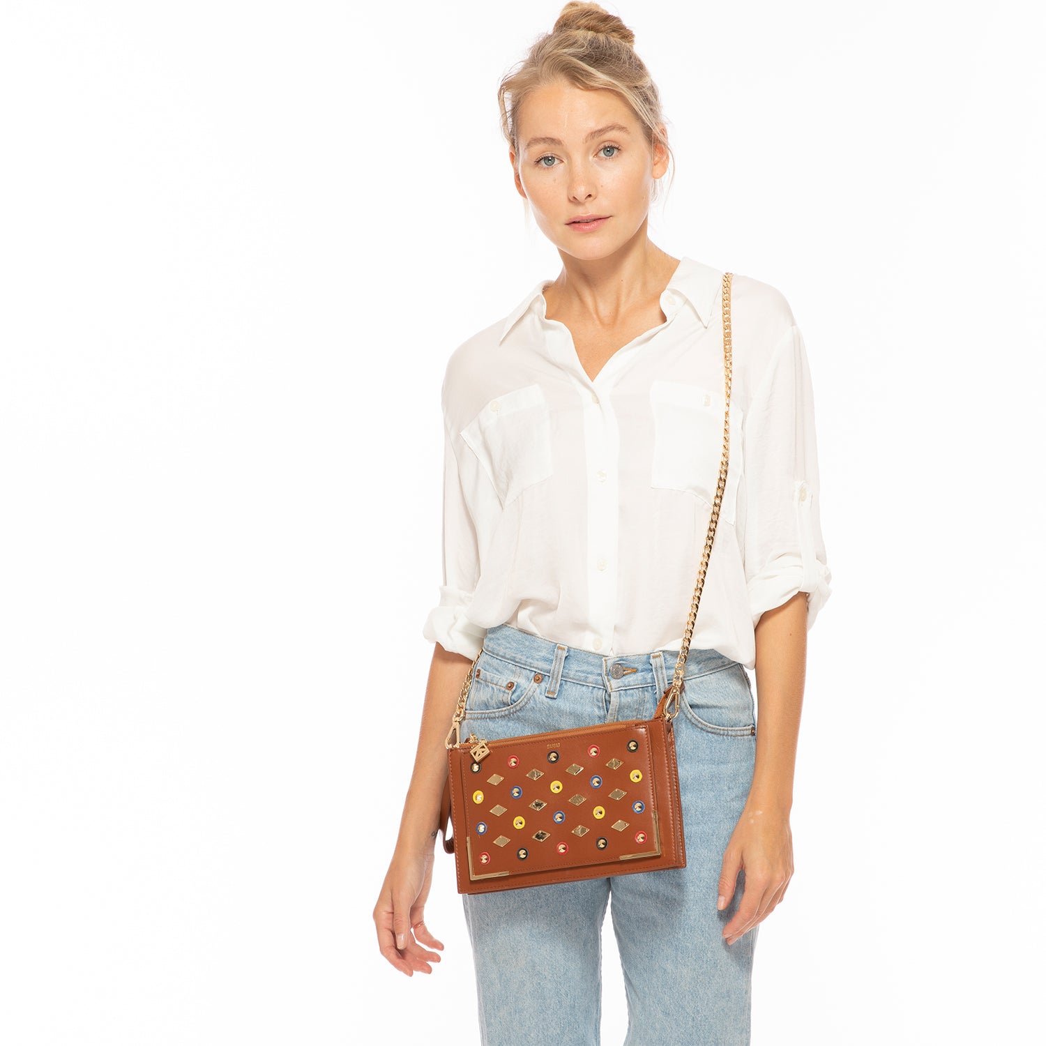 Stylish Studded Crossbody Brown Clutch with gold hardware and leather appliques, featuring a chic square silhouette.