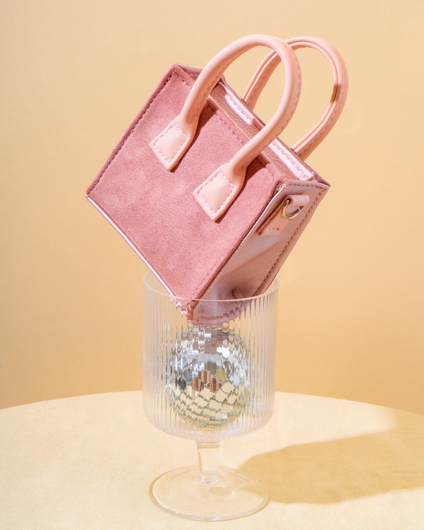 Sugar Cube Micro Bag in Animal Print Pink, showcasing its unique dual design and compact size.