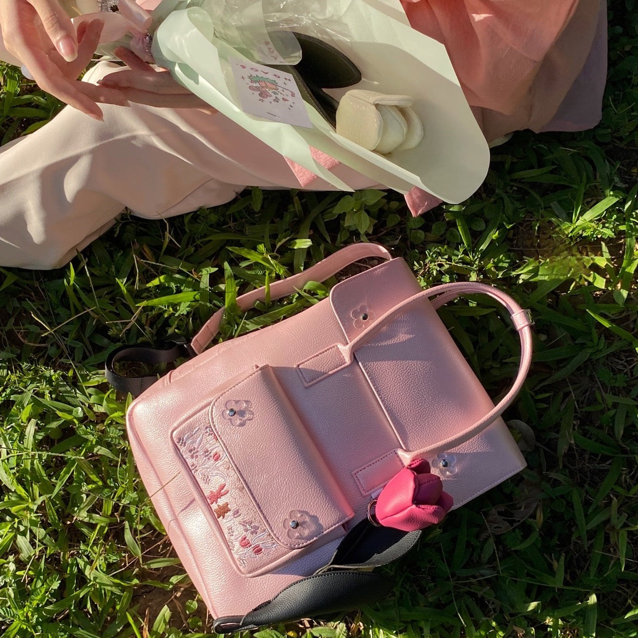 Sunny Day Backpack made from recycled PVC fabric with transparent acrylic flowers and a quilted back for comfort.