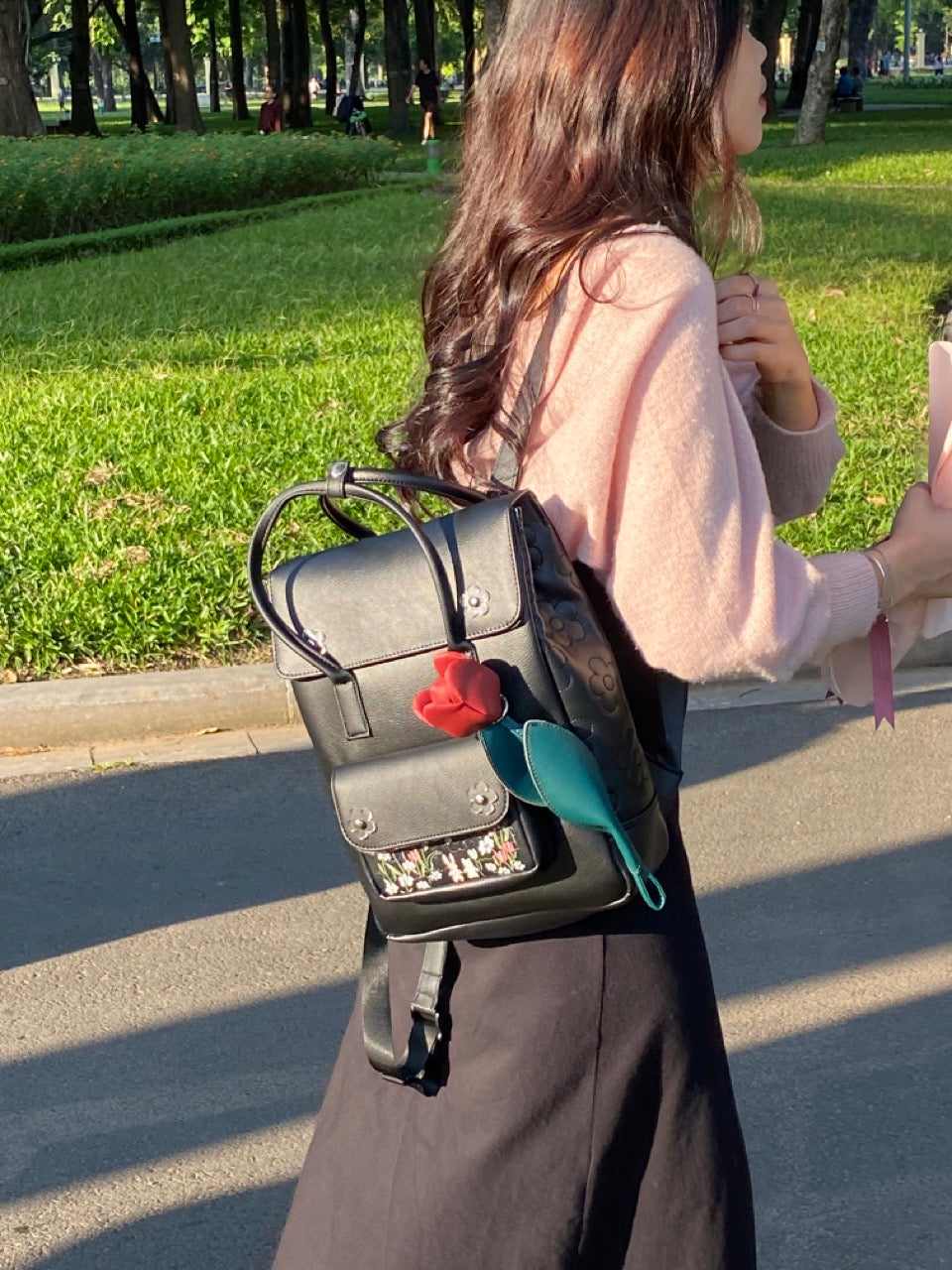 Sunny Day Backpack made from recycled PVC fabric with transparent acrylic flowers and a quilted back for comfort.