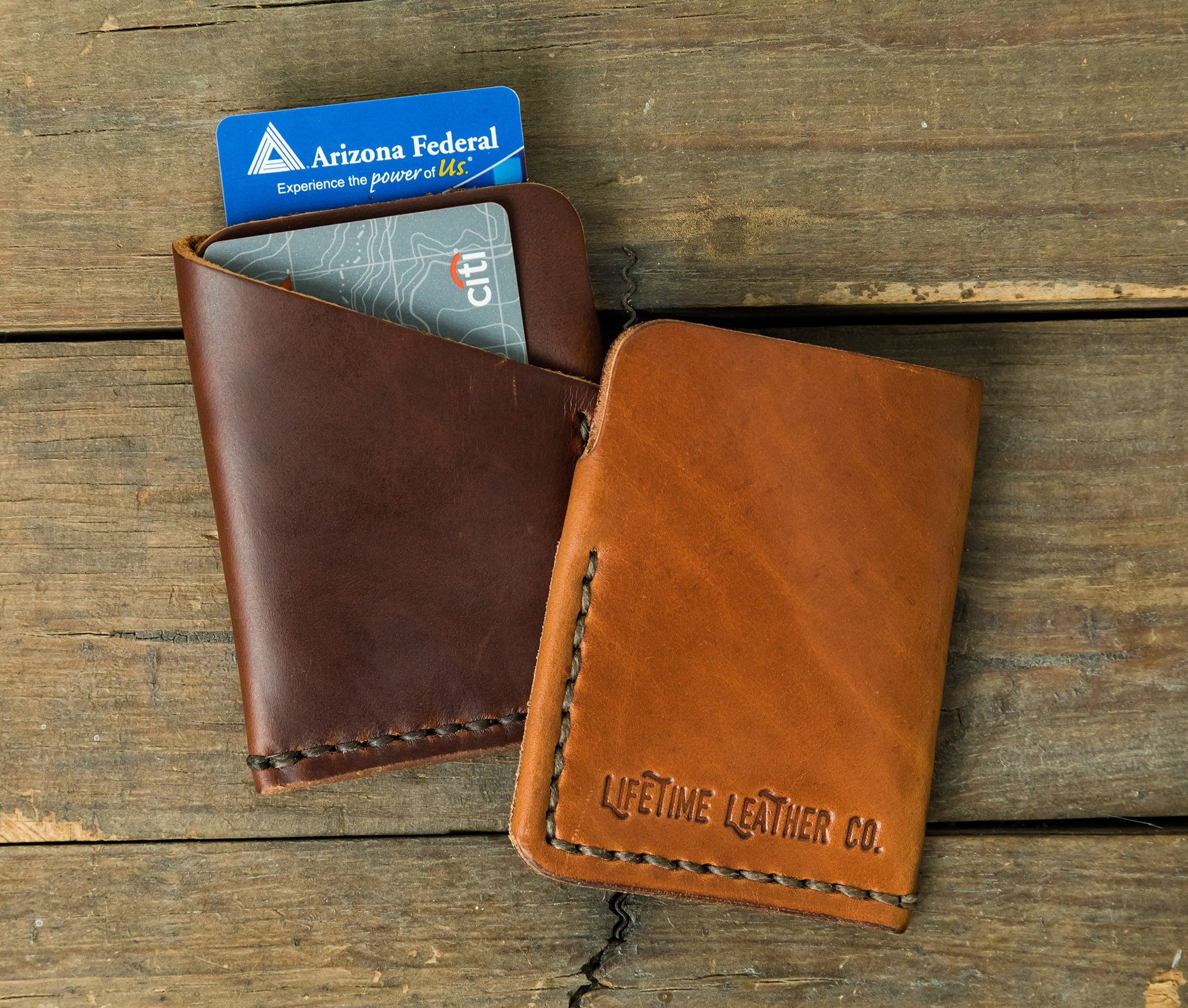 Tall Minimalist Wallet made of genuine full grain leather, featuring two card slots and a center cash slot, displayed with a muslin bag.