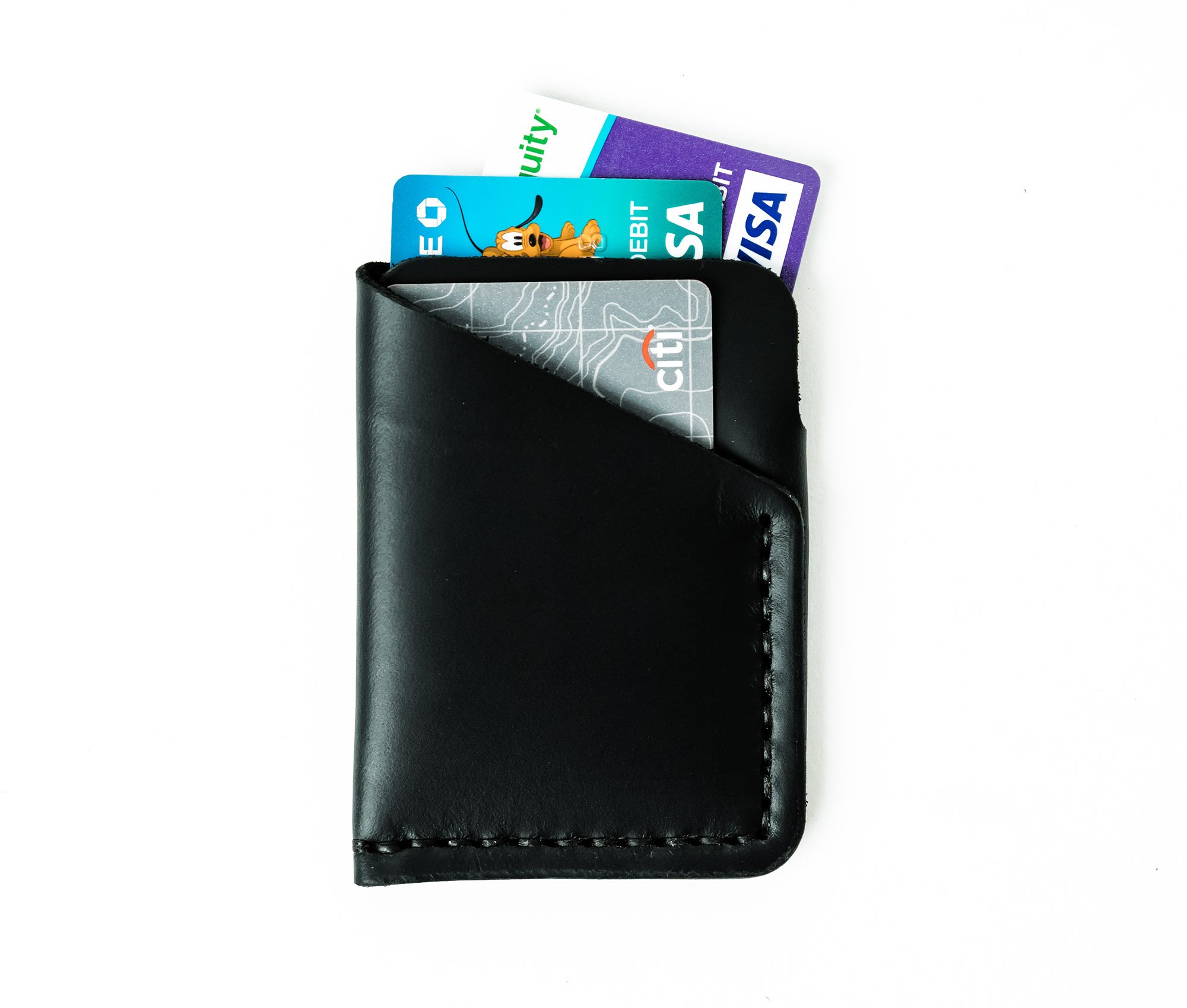 Tall Minimalist Wallet made of genuine full grain leather, featuring two card slots and a center cash slot, displayed with a muslin bag.