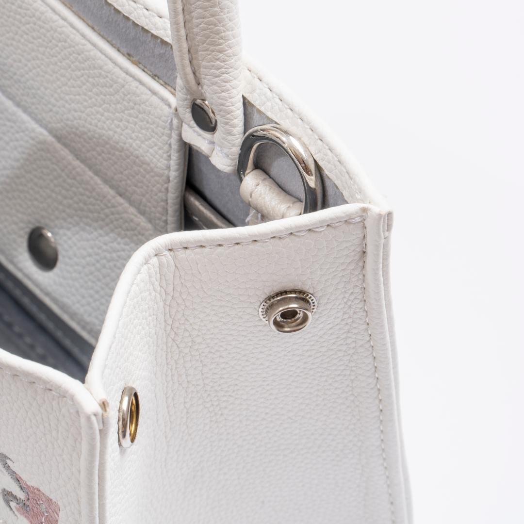 The Book Handbag featuring Jimmi Robot's epic battle design with 3D glittering embroidery on high-quality vegan leather.