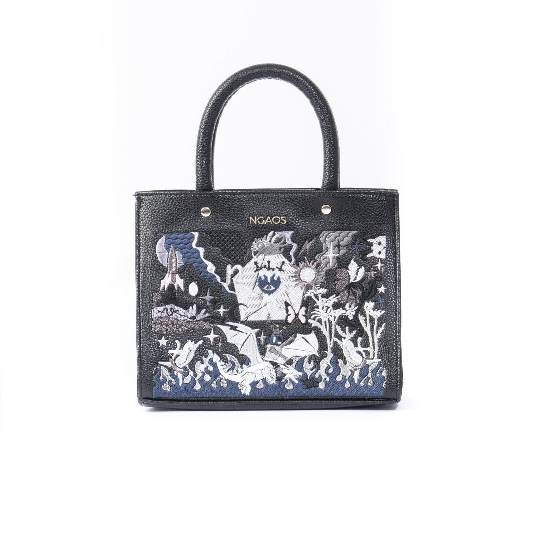 The Book Handbag featuring Jimmi Robot's epic battle design with 3D glittering embroidery on high-quality vegan leather.