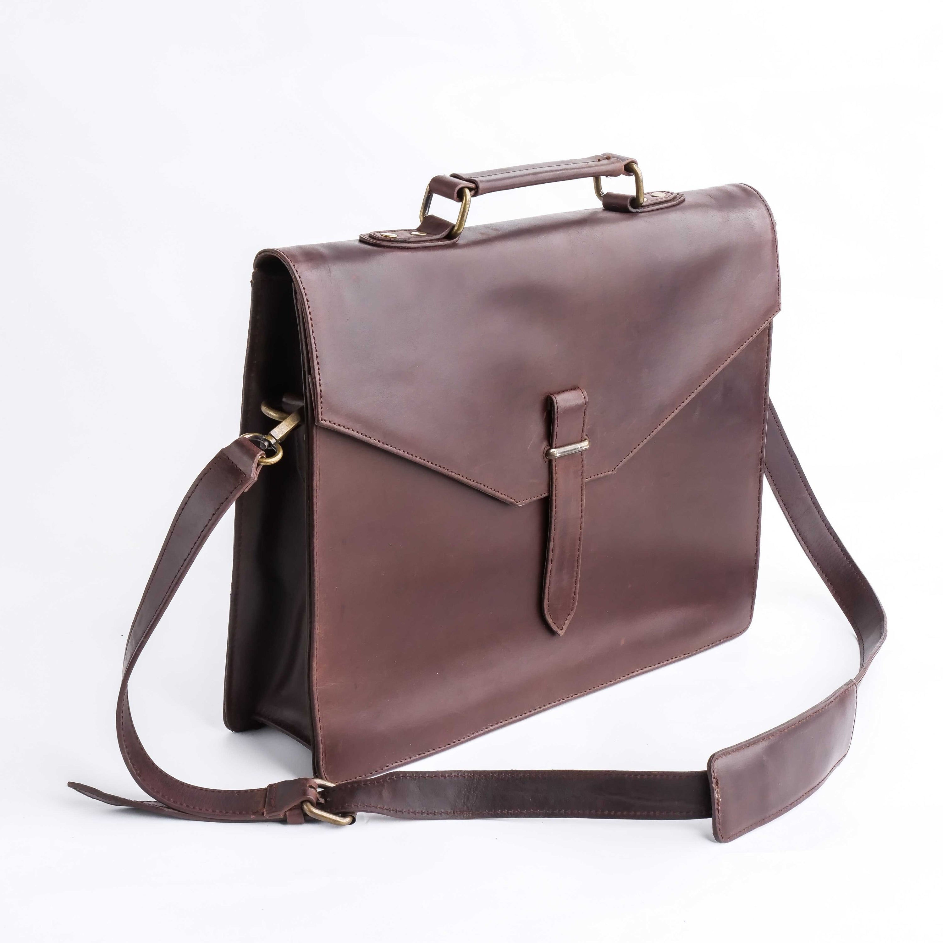 A stylish dark brown corporate pure leather bag with adjustable shoulder strap and top handle, showcasing its spacious compartments and elegant design.