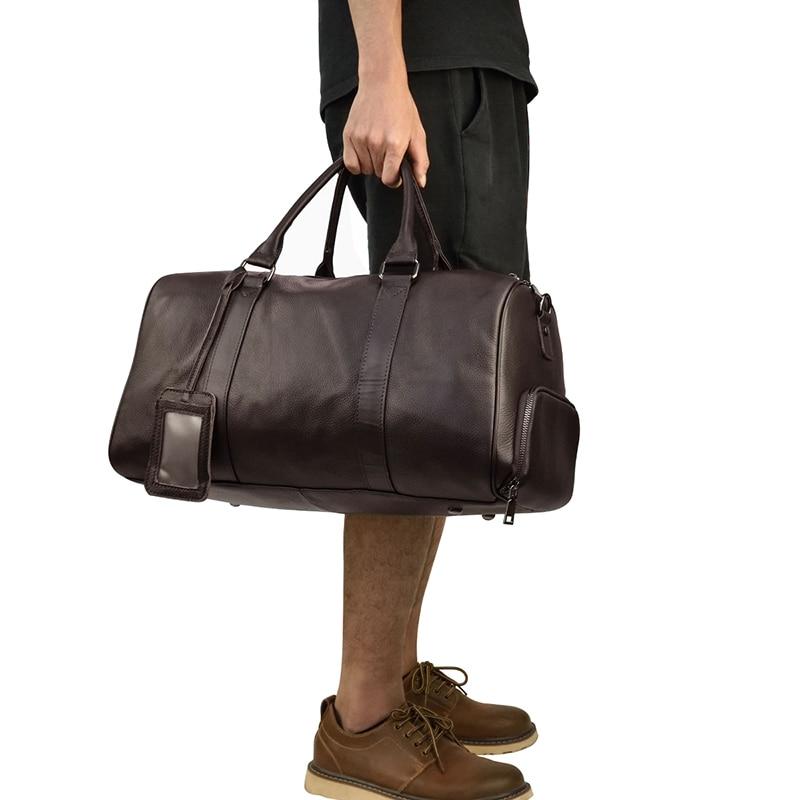 The Endre Weekender vintage leather duffle bag in black, showcasing its smooth texture and stylish design with leather handles and shoulder strap.