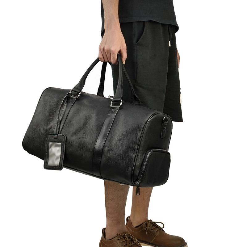 The Endre Weekender vintage leather duffle bag in black, showcasing its smooth texture and stylish design with leather handles and shoulder strap.