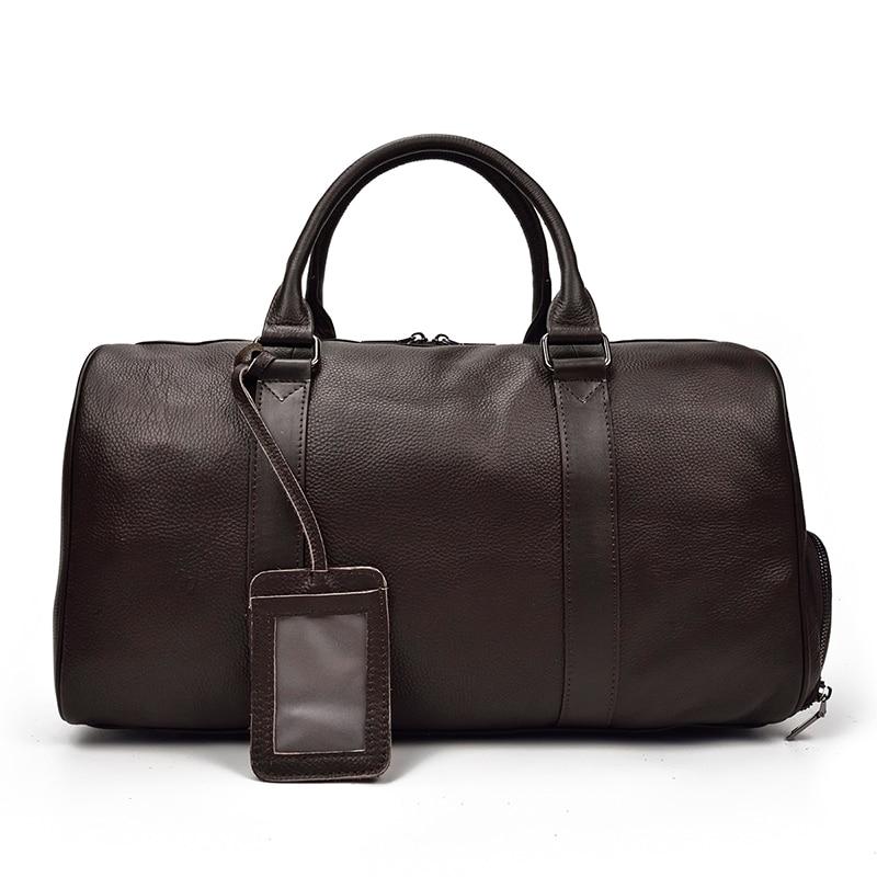 The Endre Weekender vintage leather duffle bag in black, showcasing its smooth texture and stylish design with leather handles and shoulder strap.