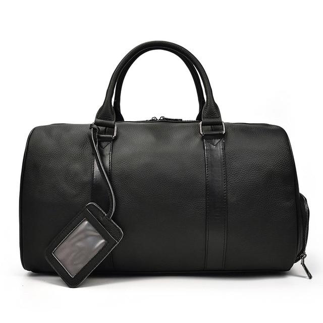 The Endre Weekender vintage leather duffle bag in black, showcasing its smooth texture and stylish design with leather handles and shoulder strap.