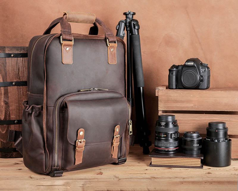 The Gaetano Large Leather Backpack Camera Bag showcasing its full grain leather design, quick access pocket, and tripod holder.