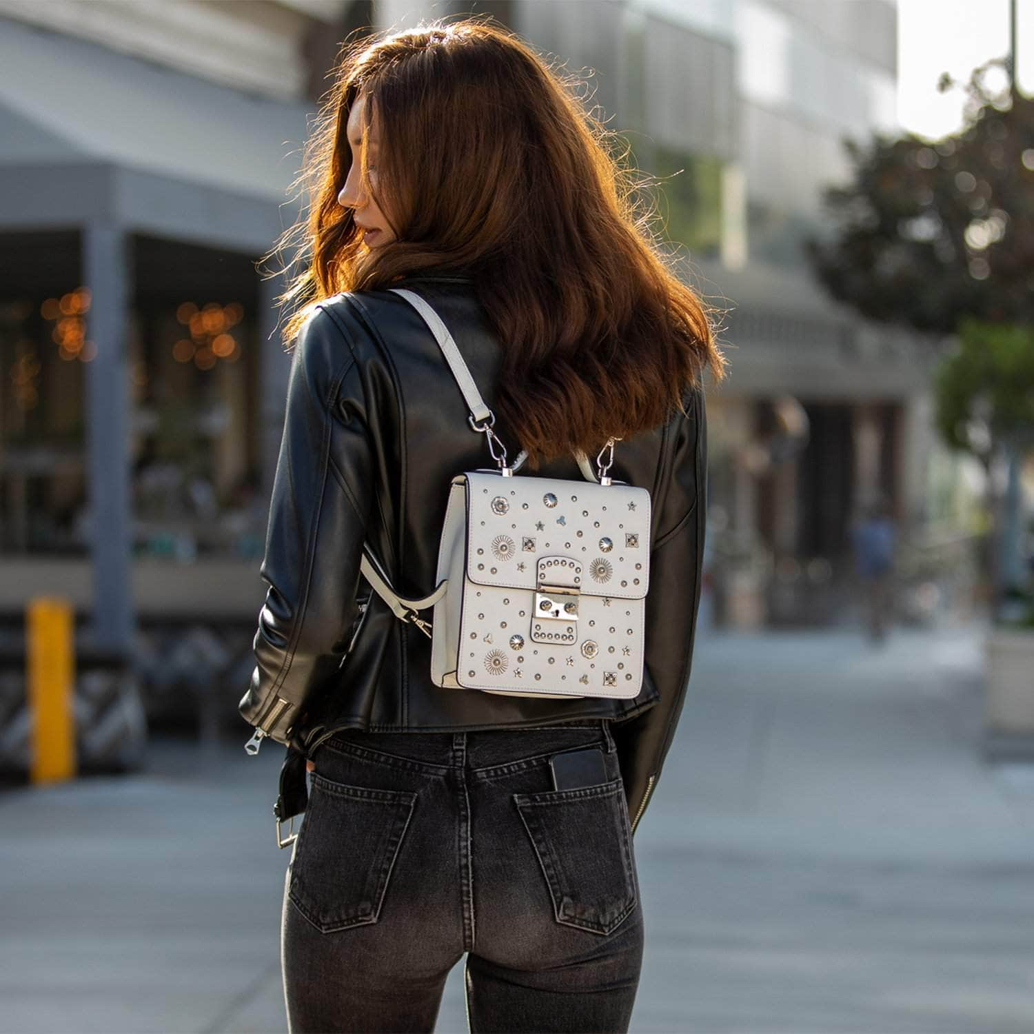 SUSU Hollywood Backpack Leather Purse in white with silver appliqués, showcasing its structured design and adjustable straps.