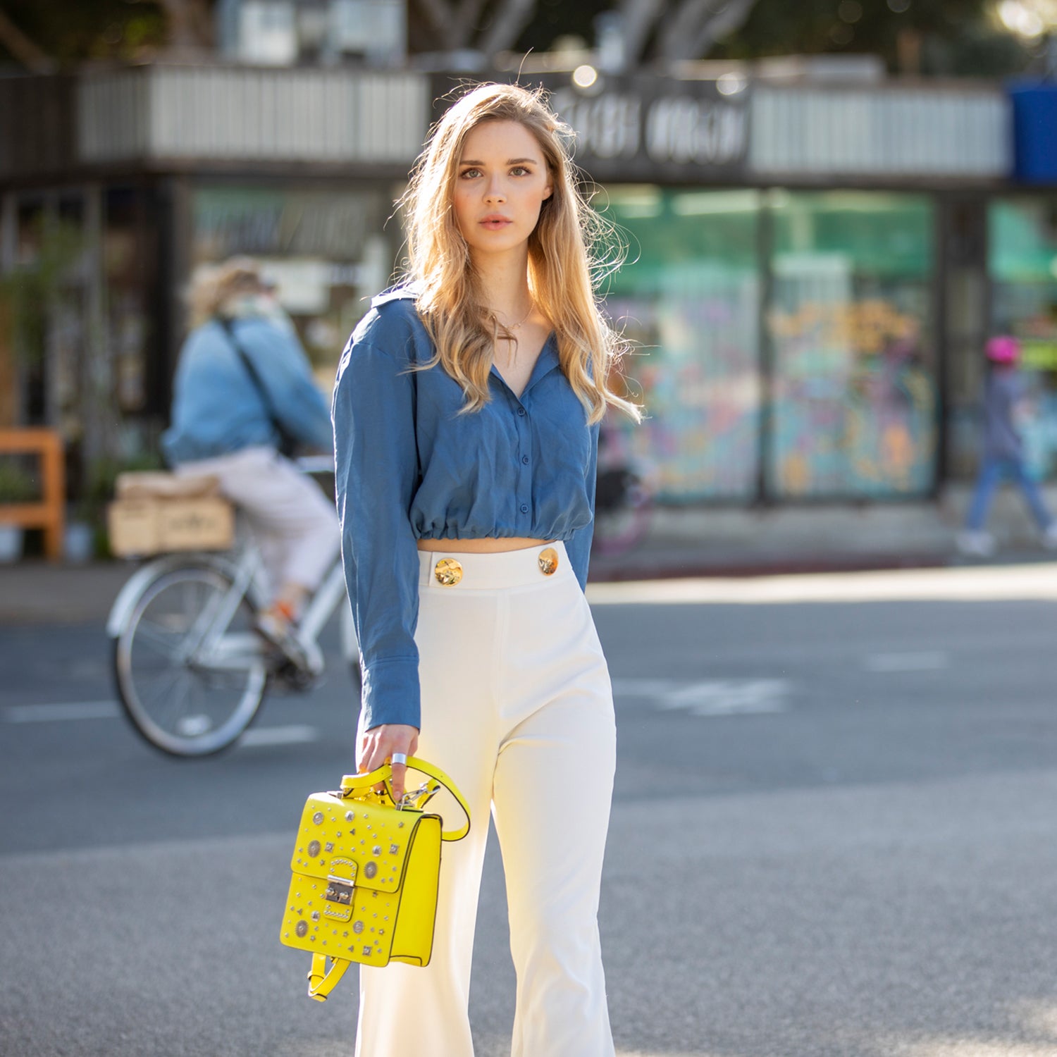 SUSU Hollywood Backpack Purse in vibrant yellow leather with silver hardware, showcasing its structured design and adjustable straps.