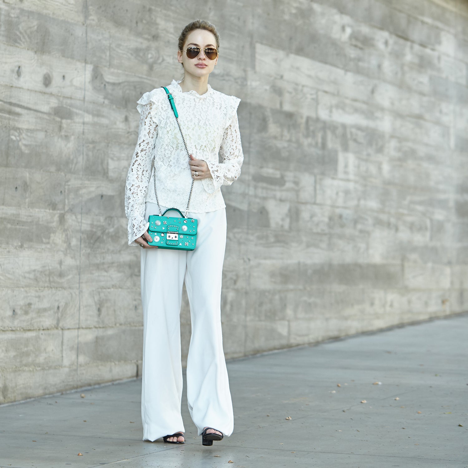 Stylish Hollywood Green Purse with silver studs and chain strap, showcasing its boxy design and elegant features.