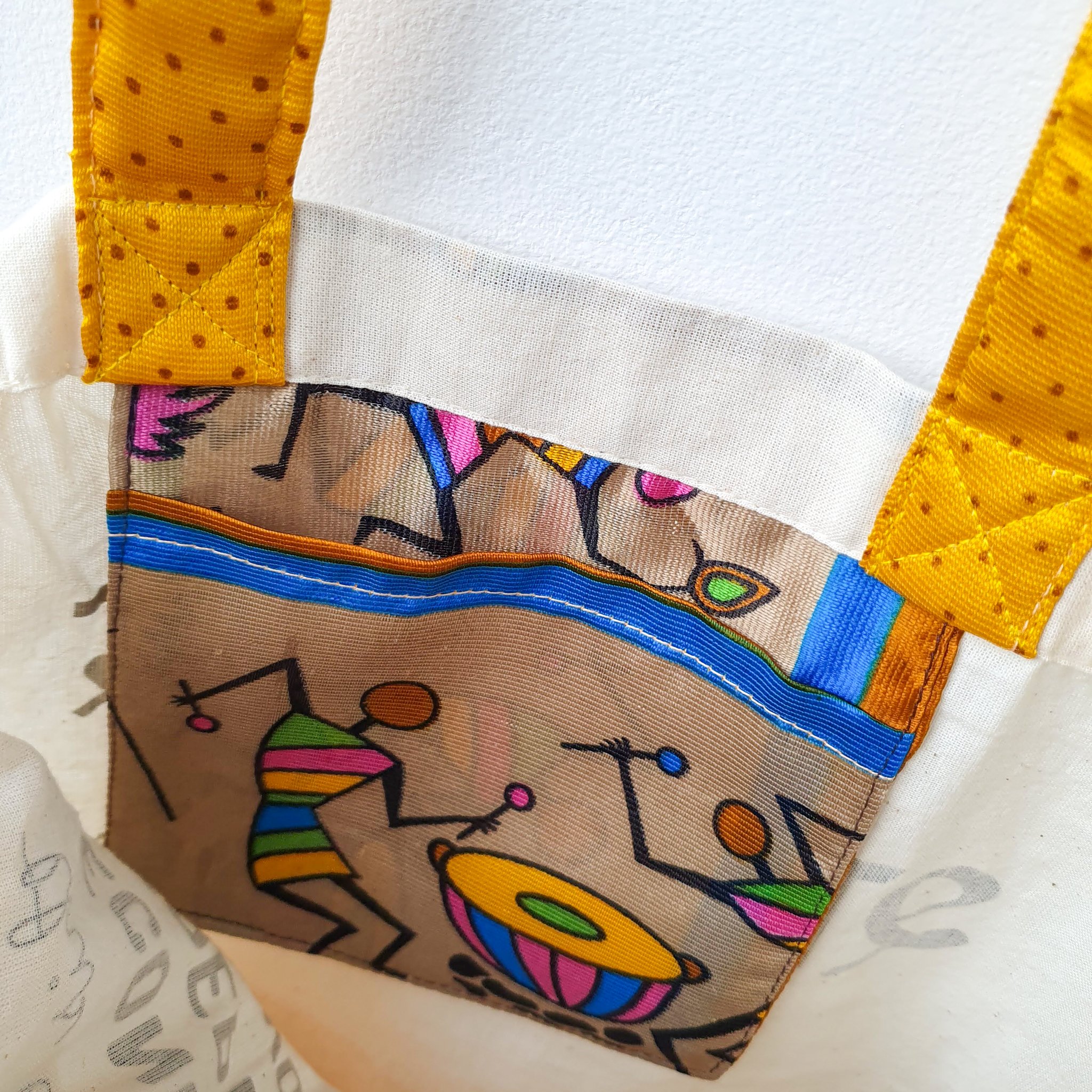 A vibrant Independence sari tote bag handcrafted from repurposed sari fabric, showcasing unique patterns and colors, with a message promoting women's economic independence.