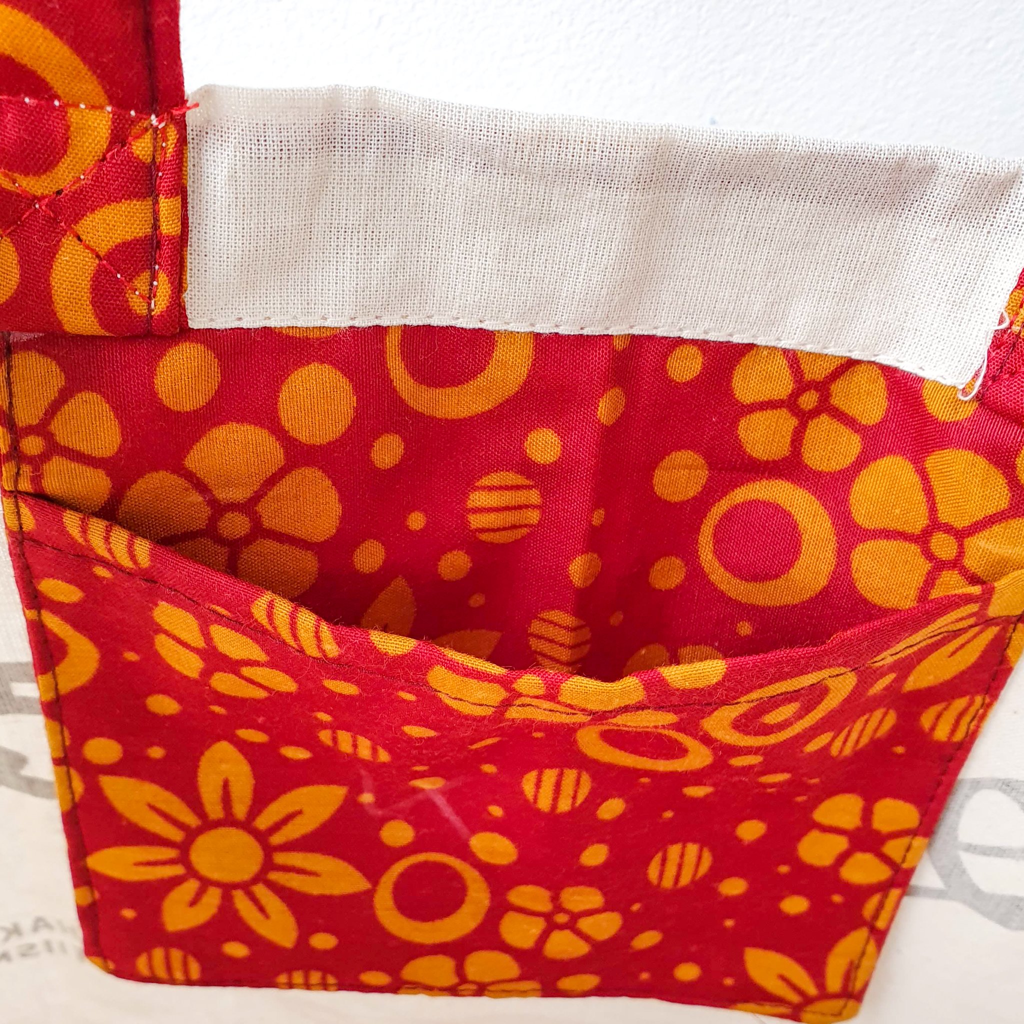 A vibrant Independence sari tote bag handcrafted from repurposed sari fabric, showcasing unique patterns and colors, with a message promoting women's economic independence.