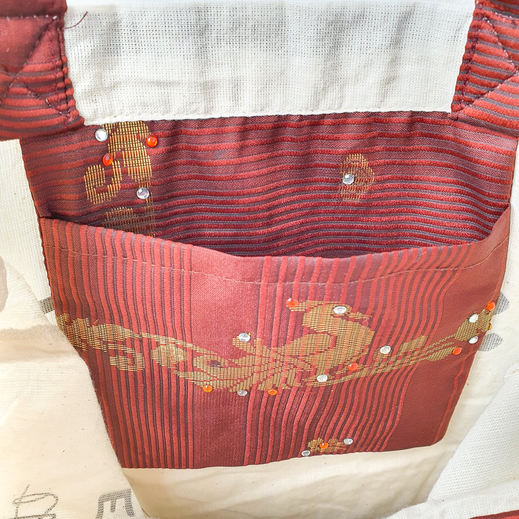 A vibrant Independence sari tote bag handcrafted from repurposed sari fabric, showcasing unique patterns and colors, with a message promoting women's economic independence.