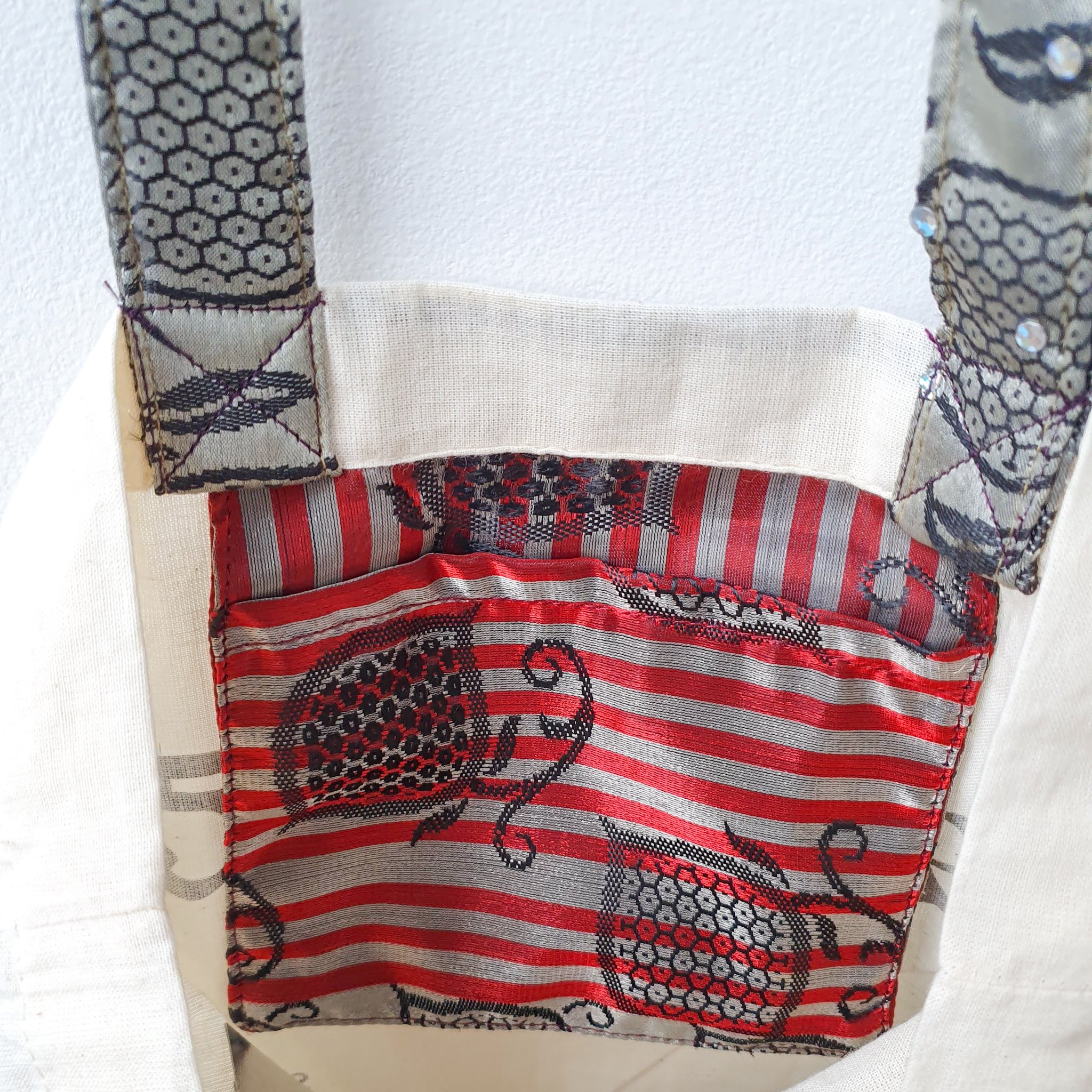 A vibrant Independence sari tote bag handcrafted from repurposed sari fabric, showcasing unique patterns and colors, with a message promoting women's economic independence.