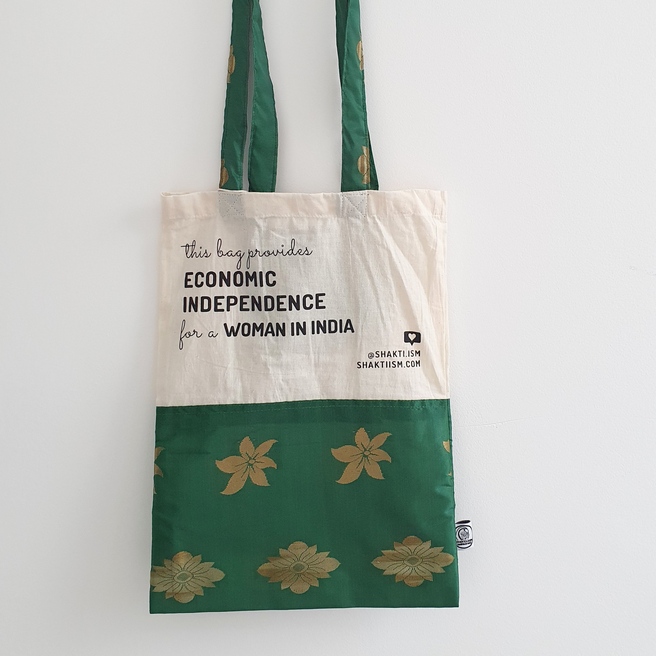 A vibrant Independence sari tote bag handcrafted from repurposed sari fabric, showcasing unique patterns and colors, with a message promoting women's economic independence.