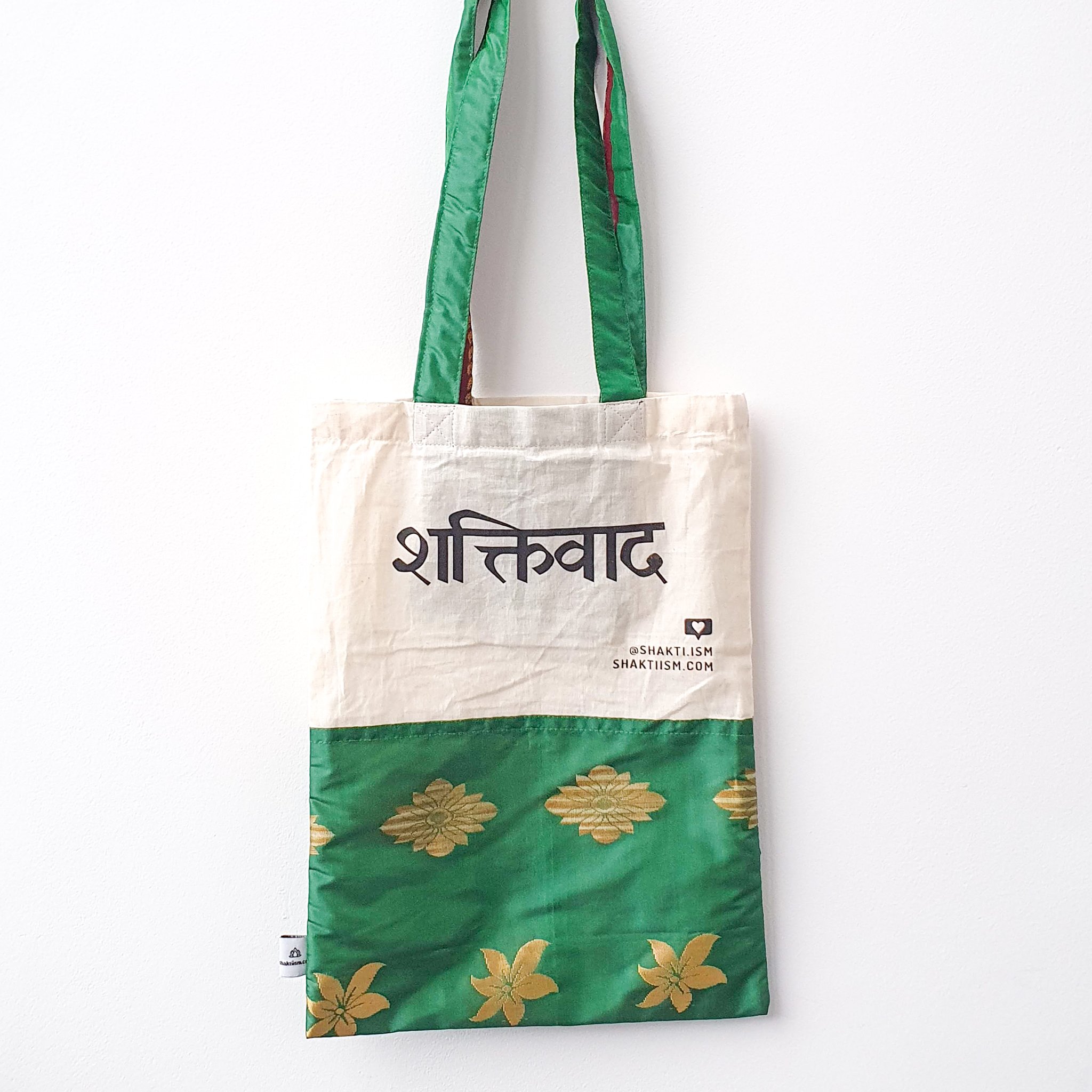 A vibrant Independence sari tote bag handcrafted from repurposed sari fabric, showcasing unique patterns and colors, with a message promoting women's economic independence.