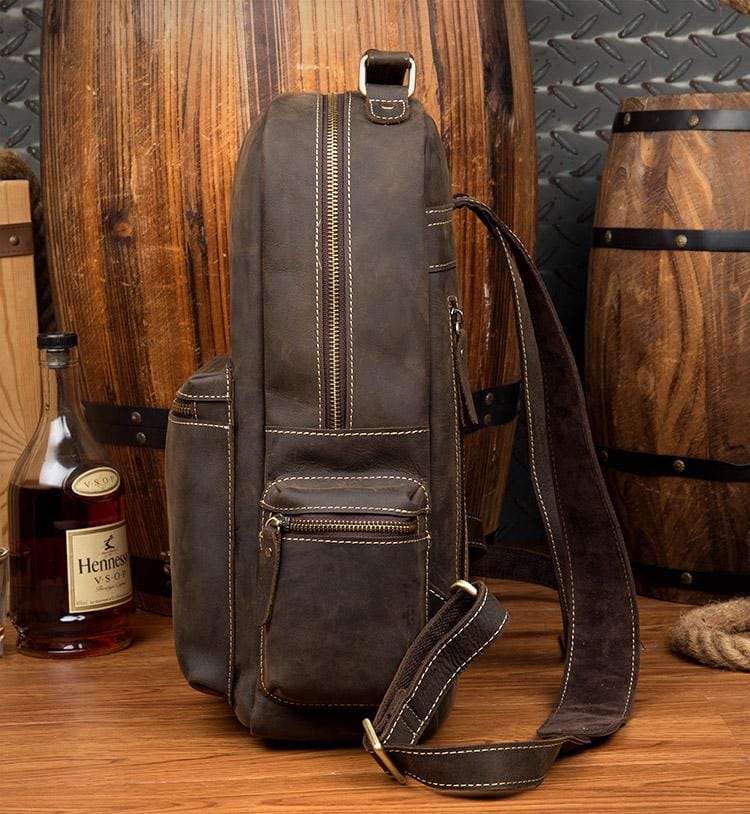 The Langley Backpack made from high-quality crazy horse leather, featuring a rustic deep chocolate brown color and multiple compartments.