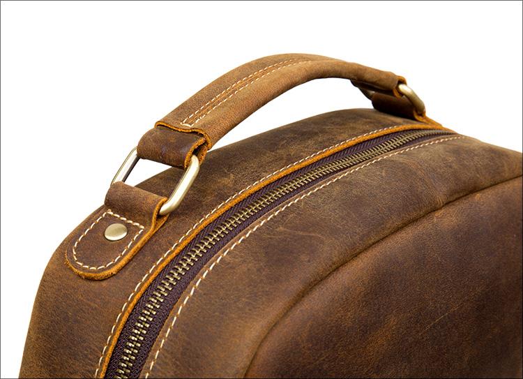 The Langley Backpack made from high-quality crazy horse leather, featuring a rustic deep chocolate brown color and multiple compartments.