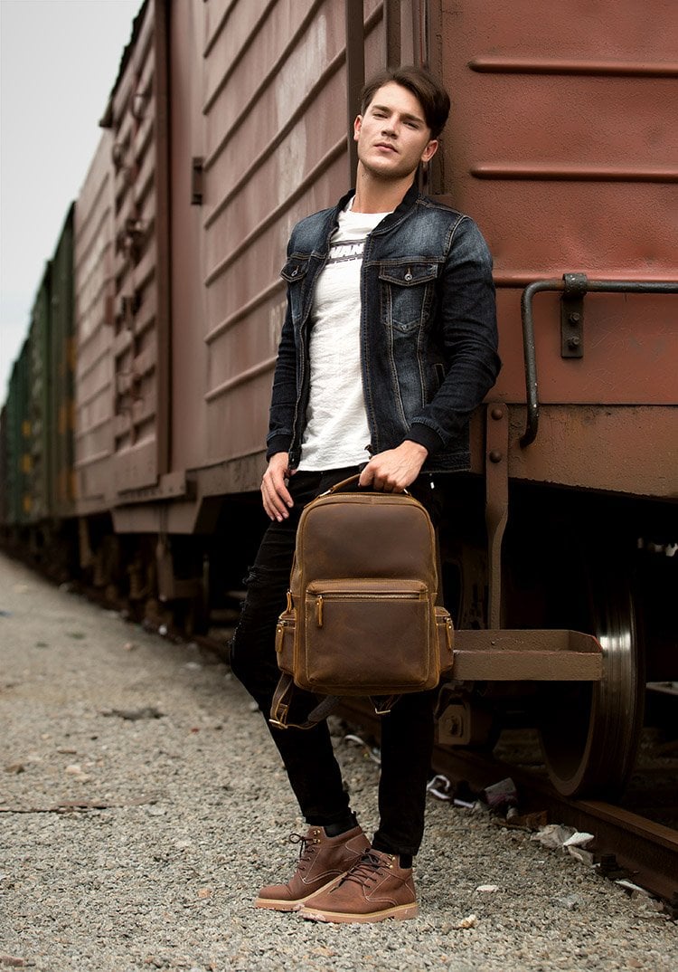 The Langley Backpack made from high-quality crazy horse leather, featuring a rustic deep chocolate brown color and multiple compartments.