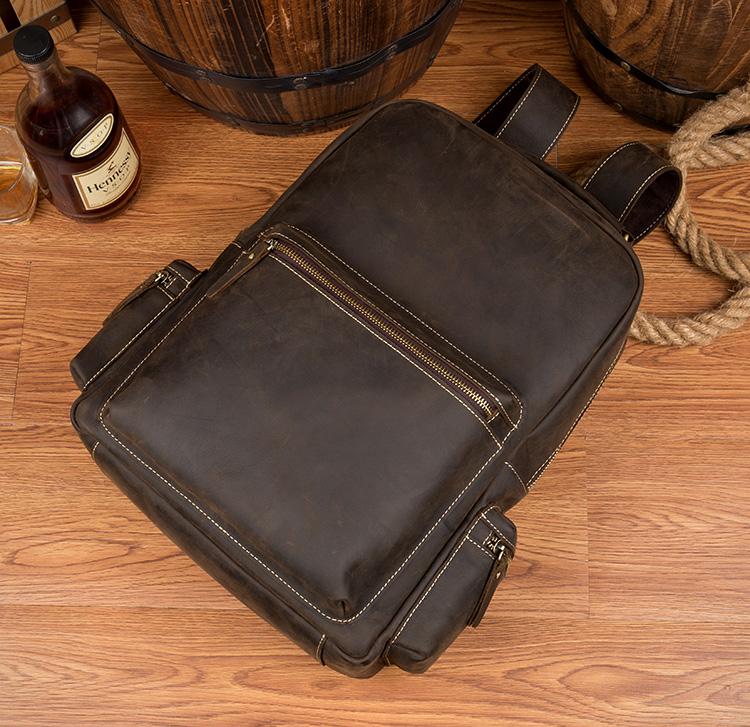 The Langley Backpack made from high-quality crazy horse leather, featuring a rustic deep chocolate brown color and multiple compartments.